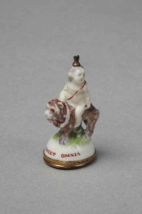 Porcelain Figurine of Child Riding Bulldog