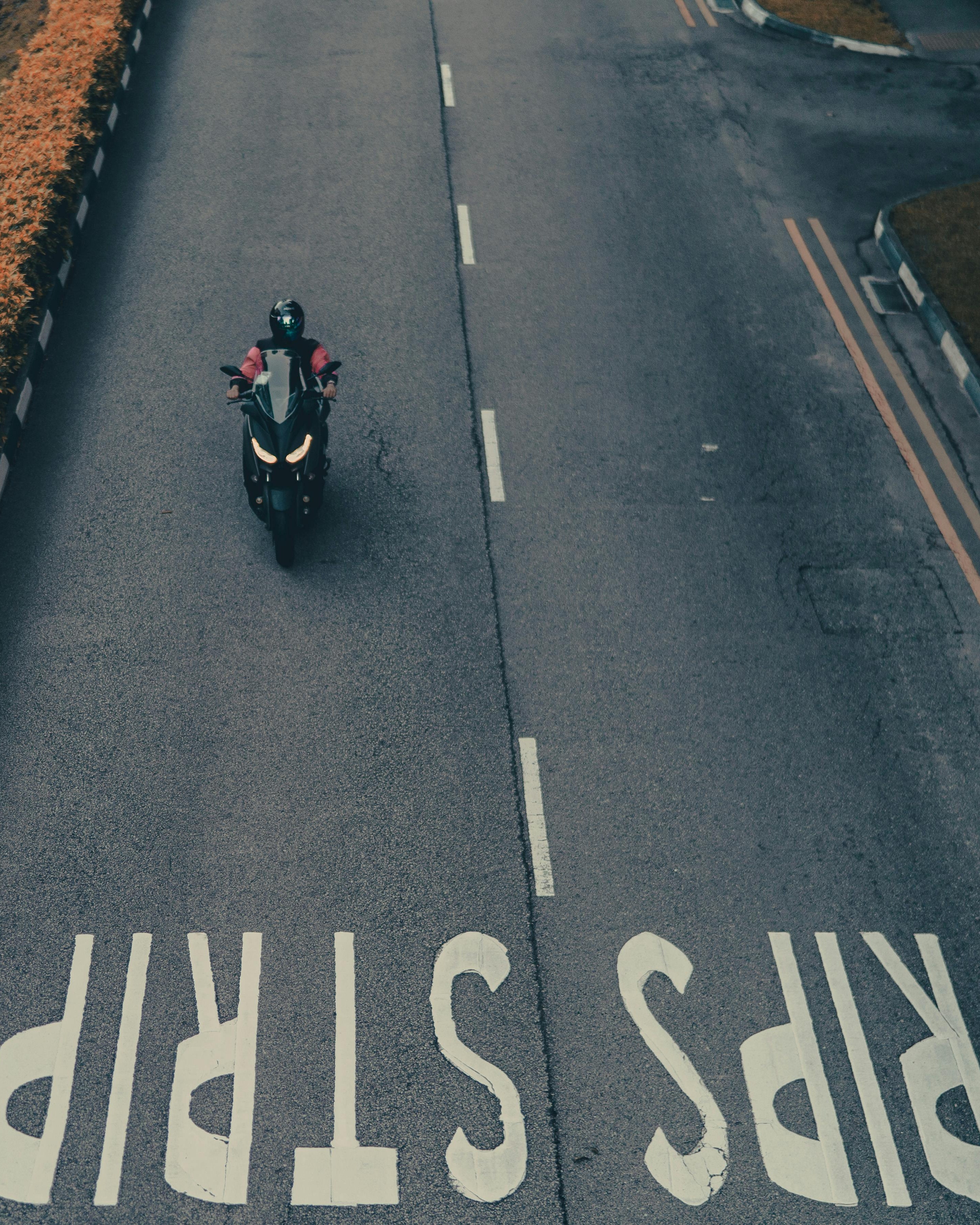 Motorcyclist Riding on Empty Road