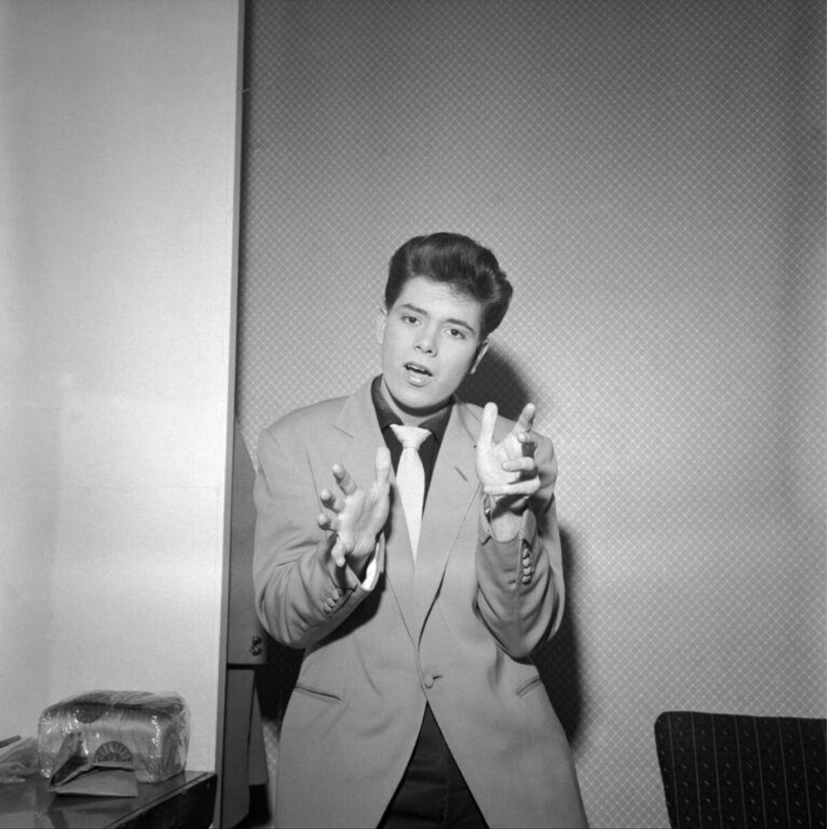 Young Man In Suit Gesturing