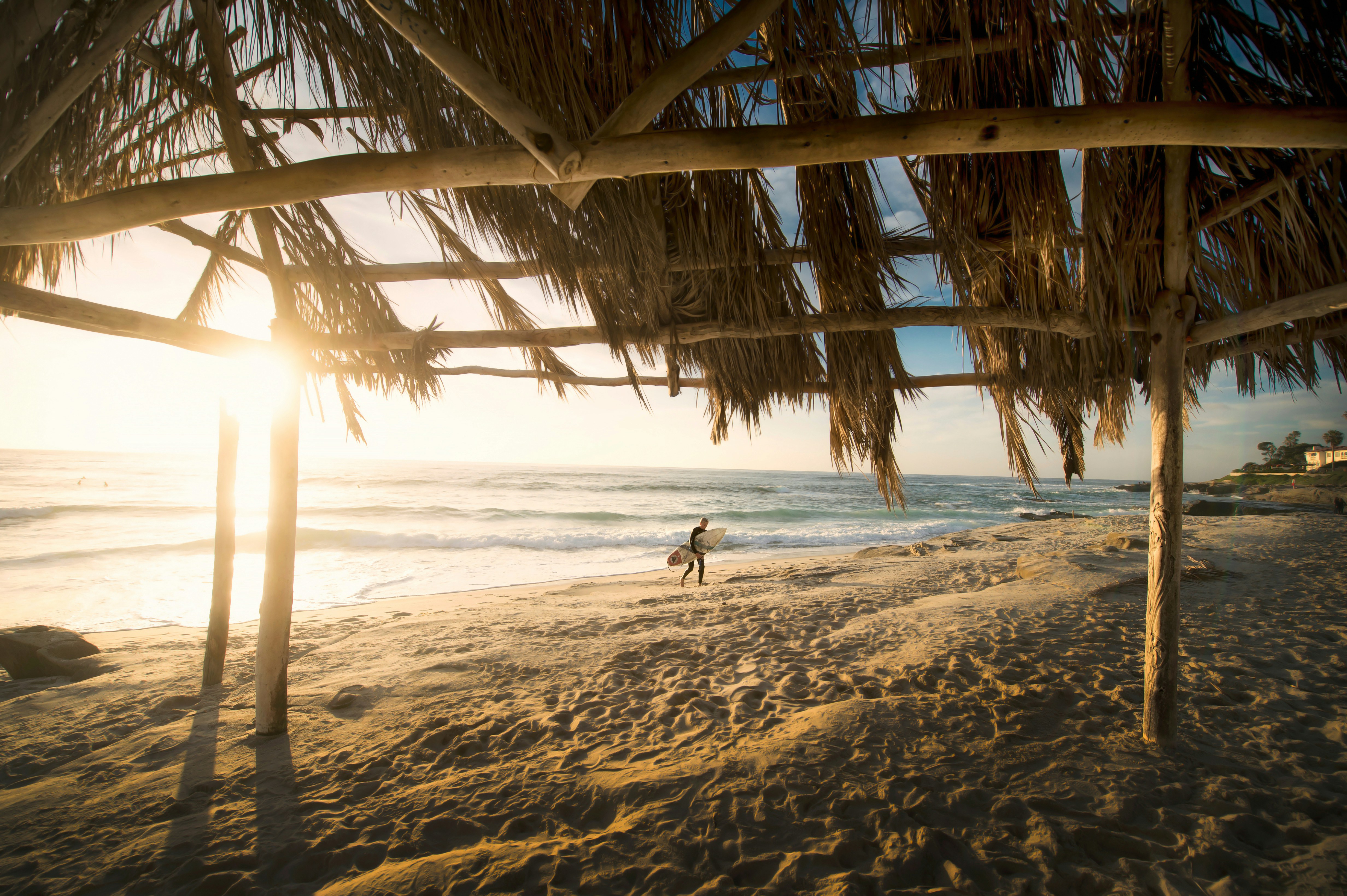 Surfer Walking on Sunset Beach