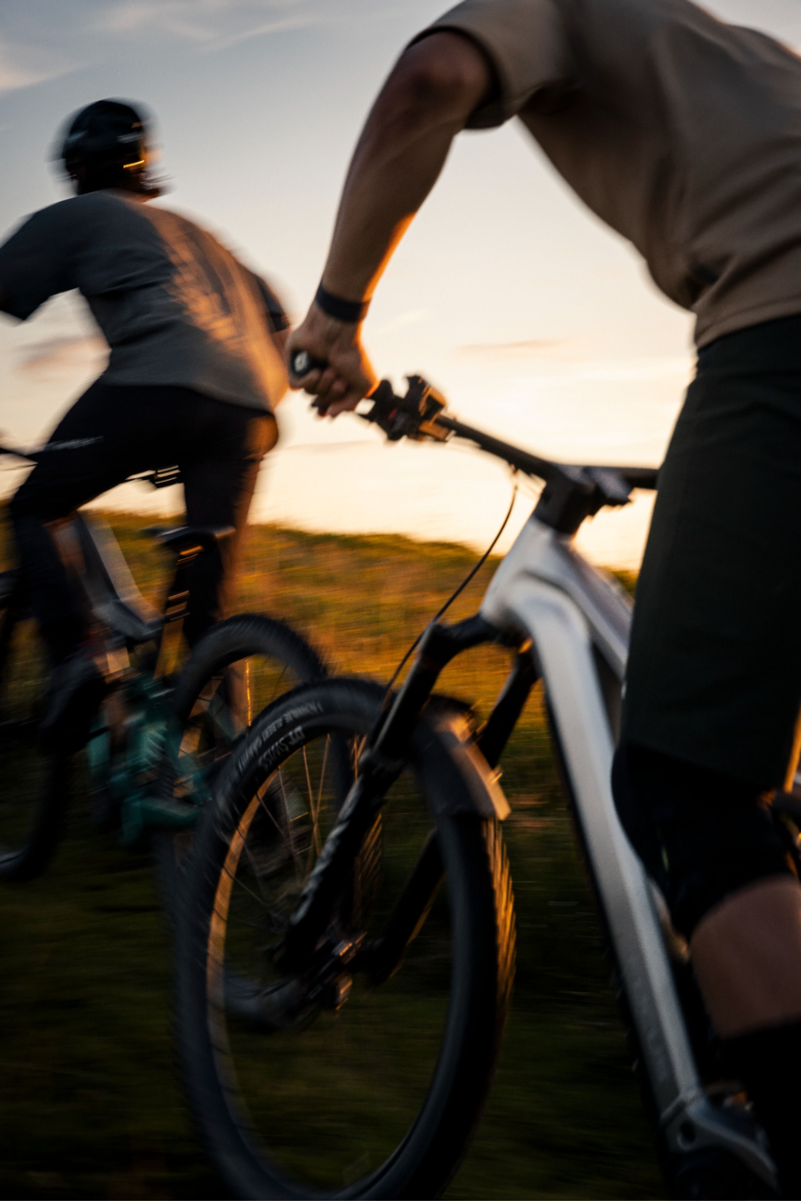 Two Mountain Bikers Riding at Sunset