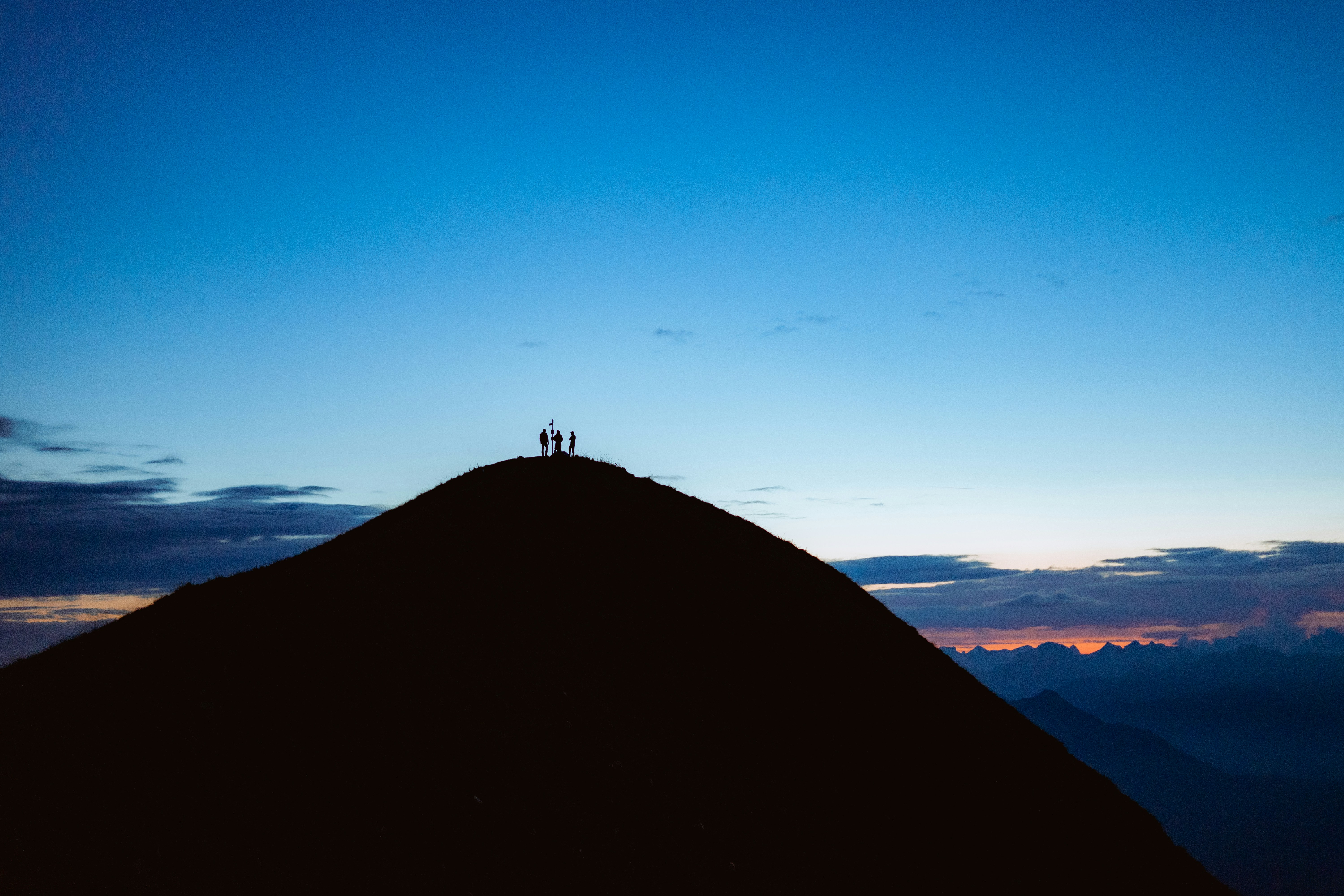 Hikers on Mountain Peak at Twilight