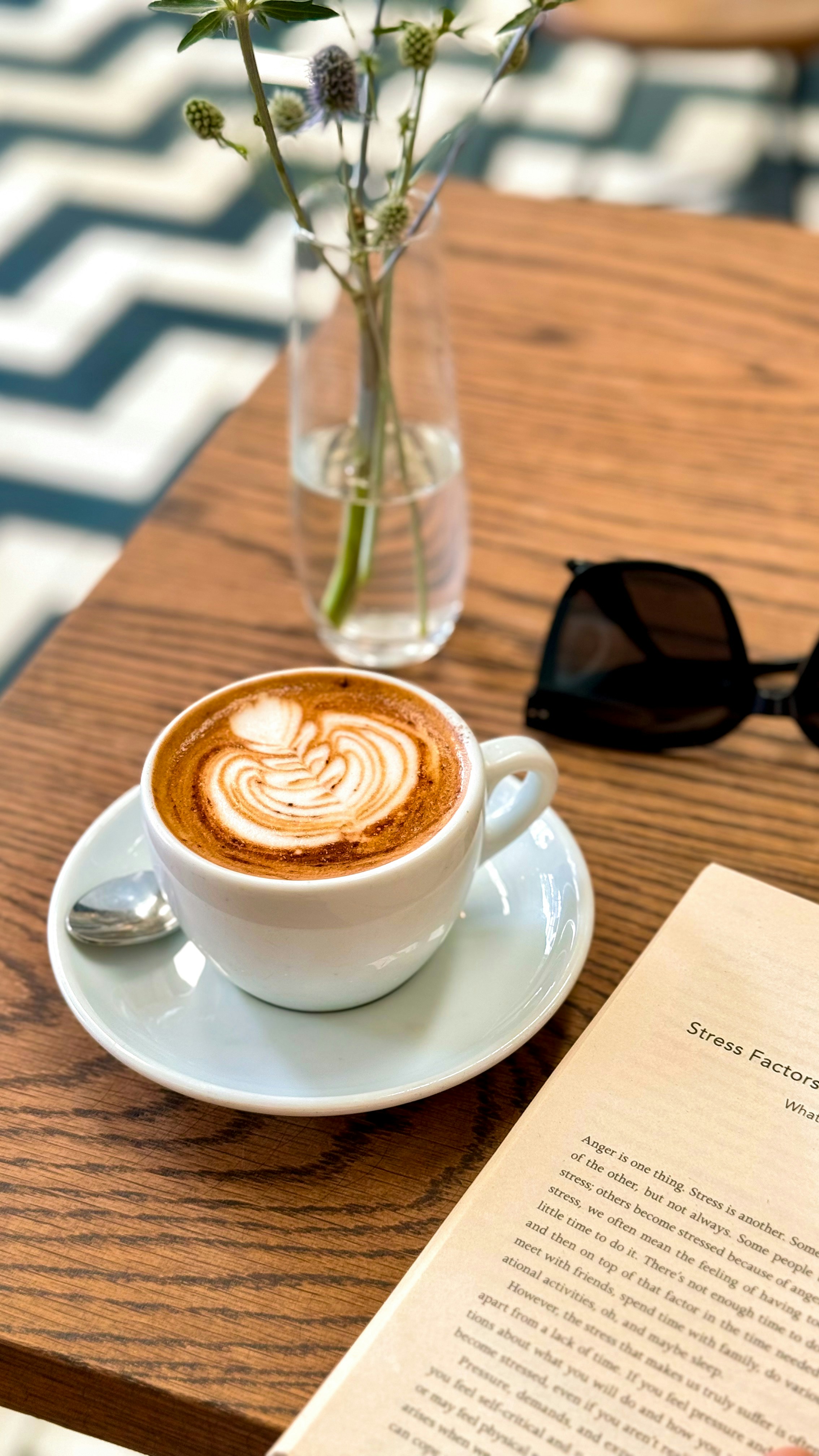 Latte Coffee and Book on Cafe Table