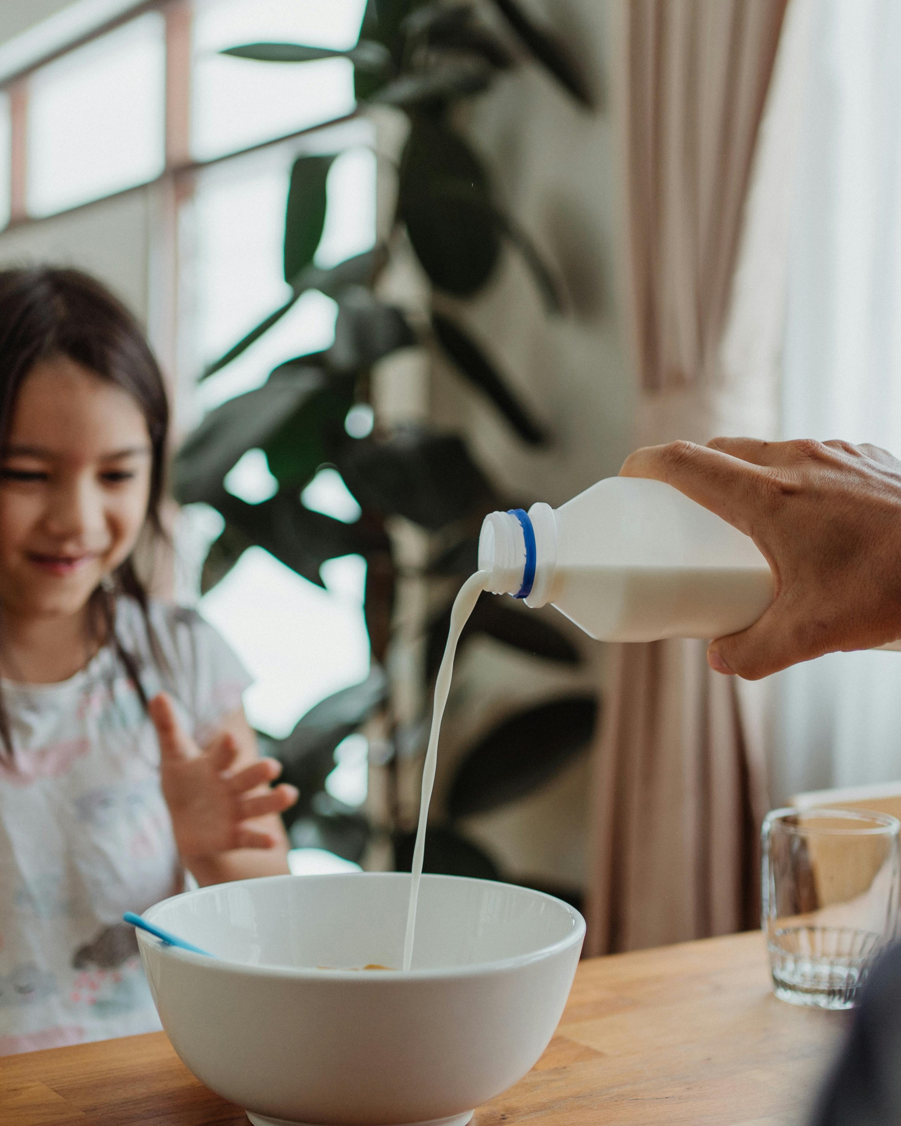 Pouring Milk into Cereal Bowl