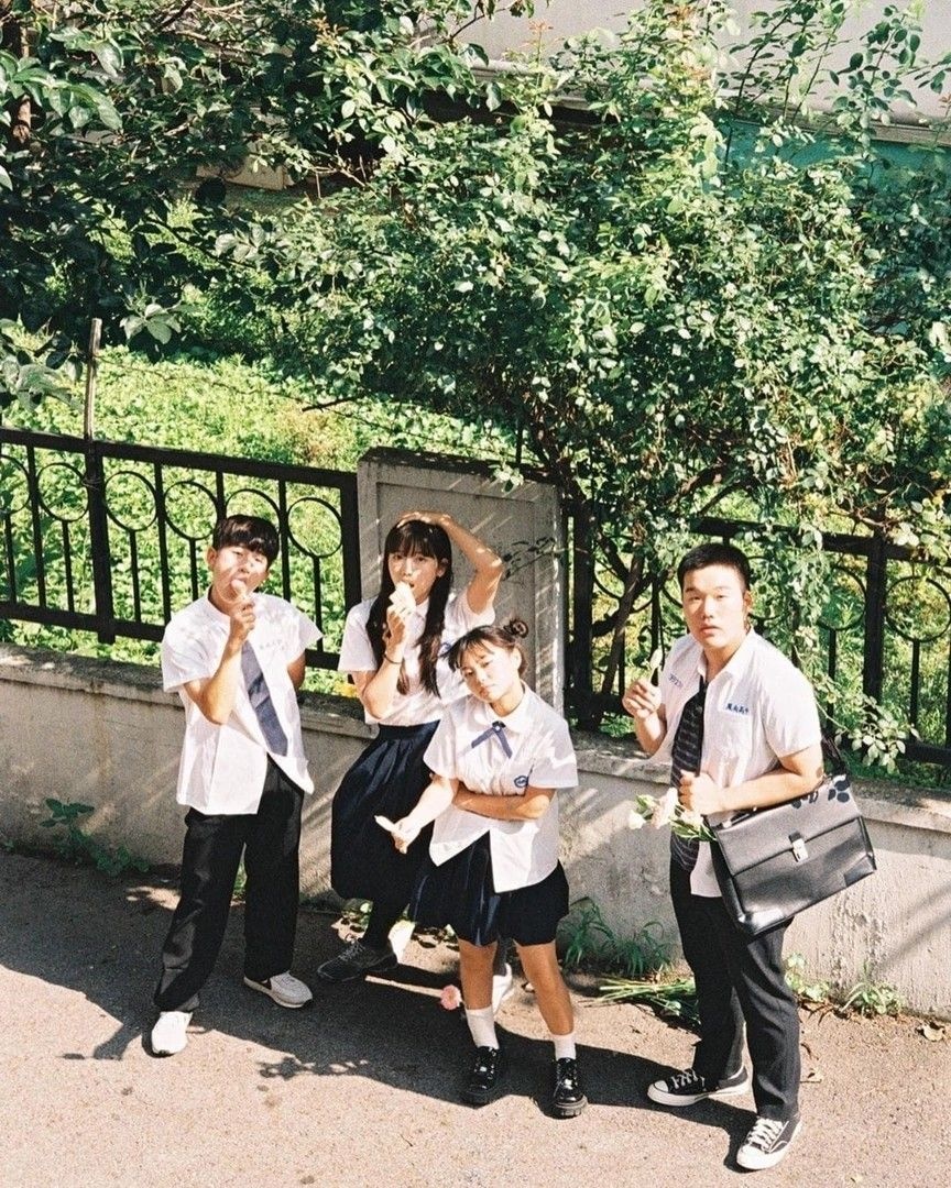 Four Students in Uniform Posing Outdoors