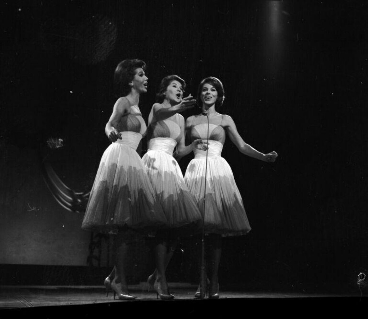 Three Singers Performing on Stage