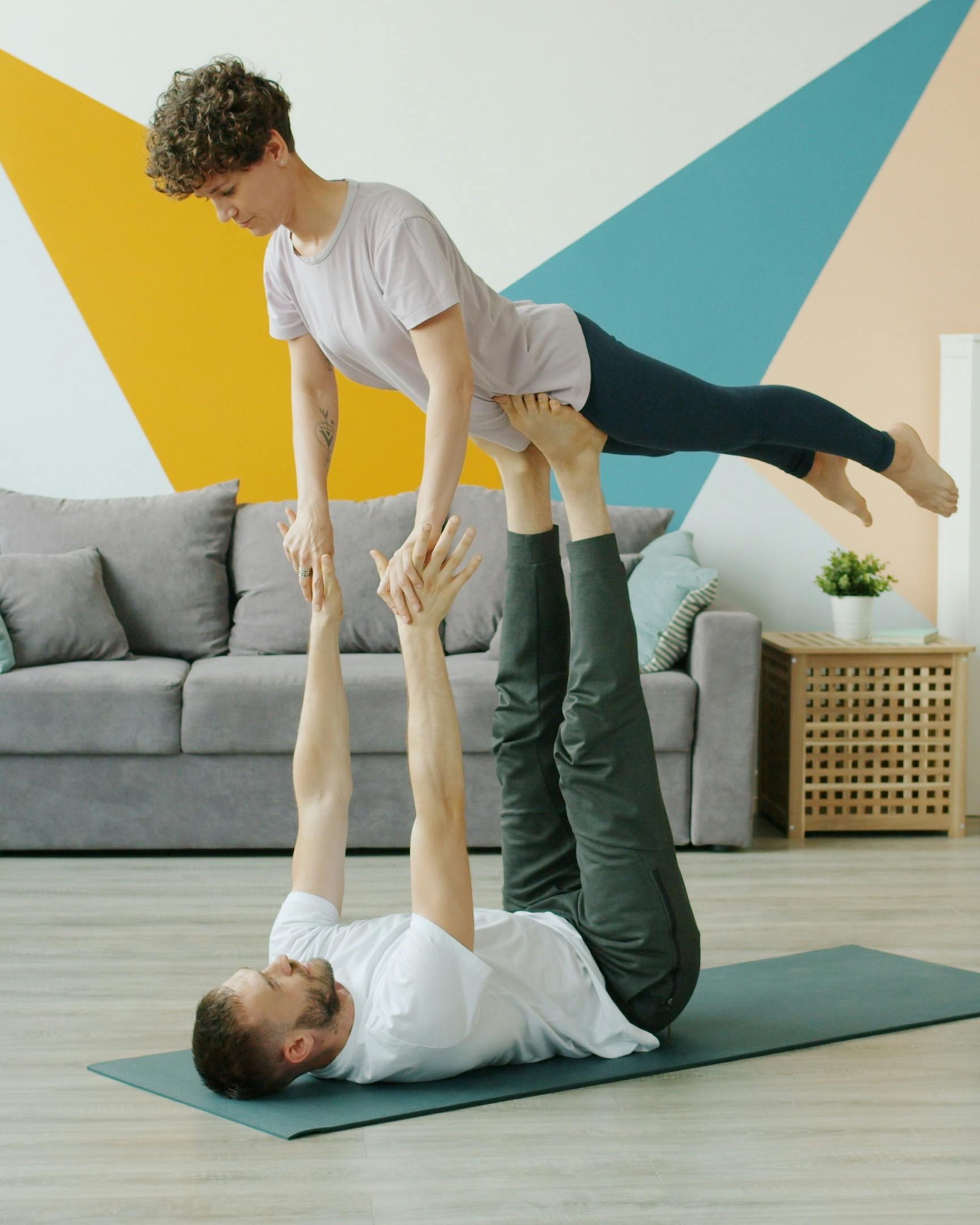 Couple Doing Partner Acro Yoga at Home