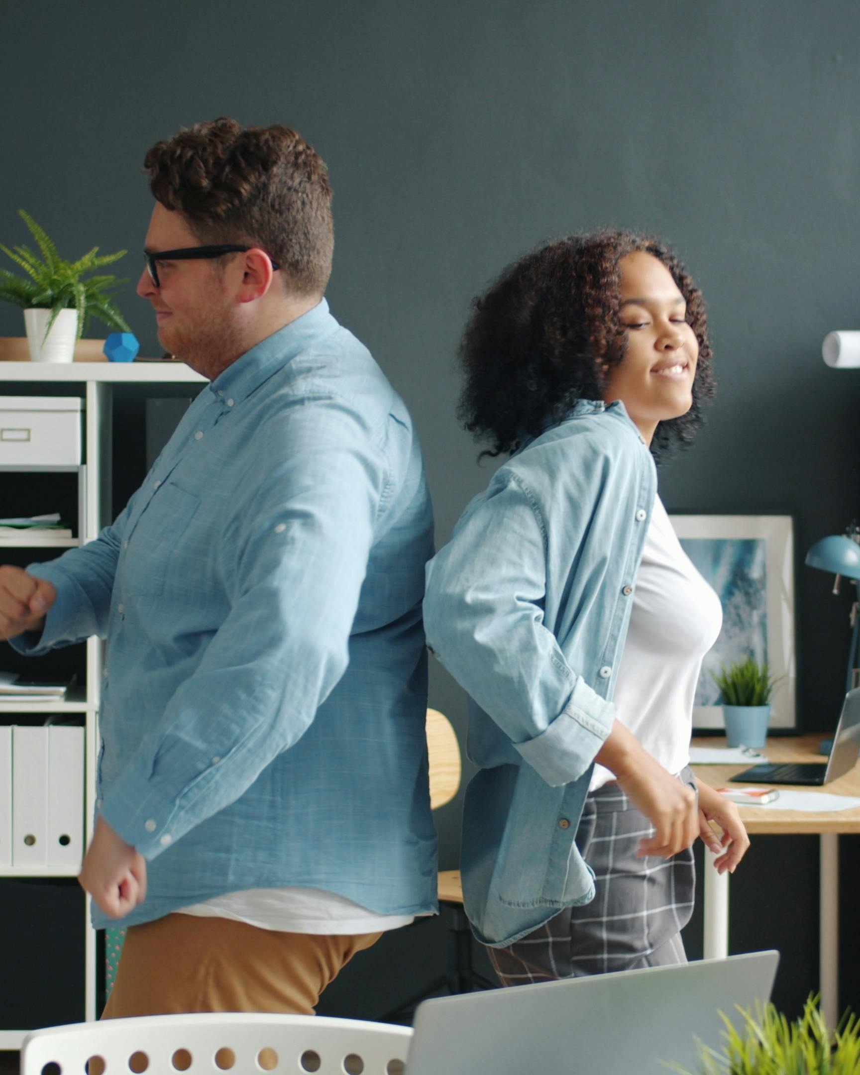 Two Coworkers Dancing In Office