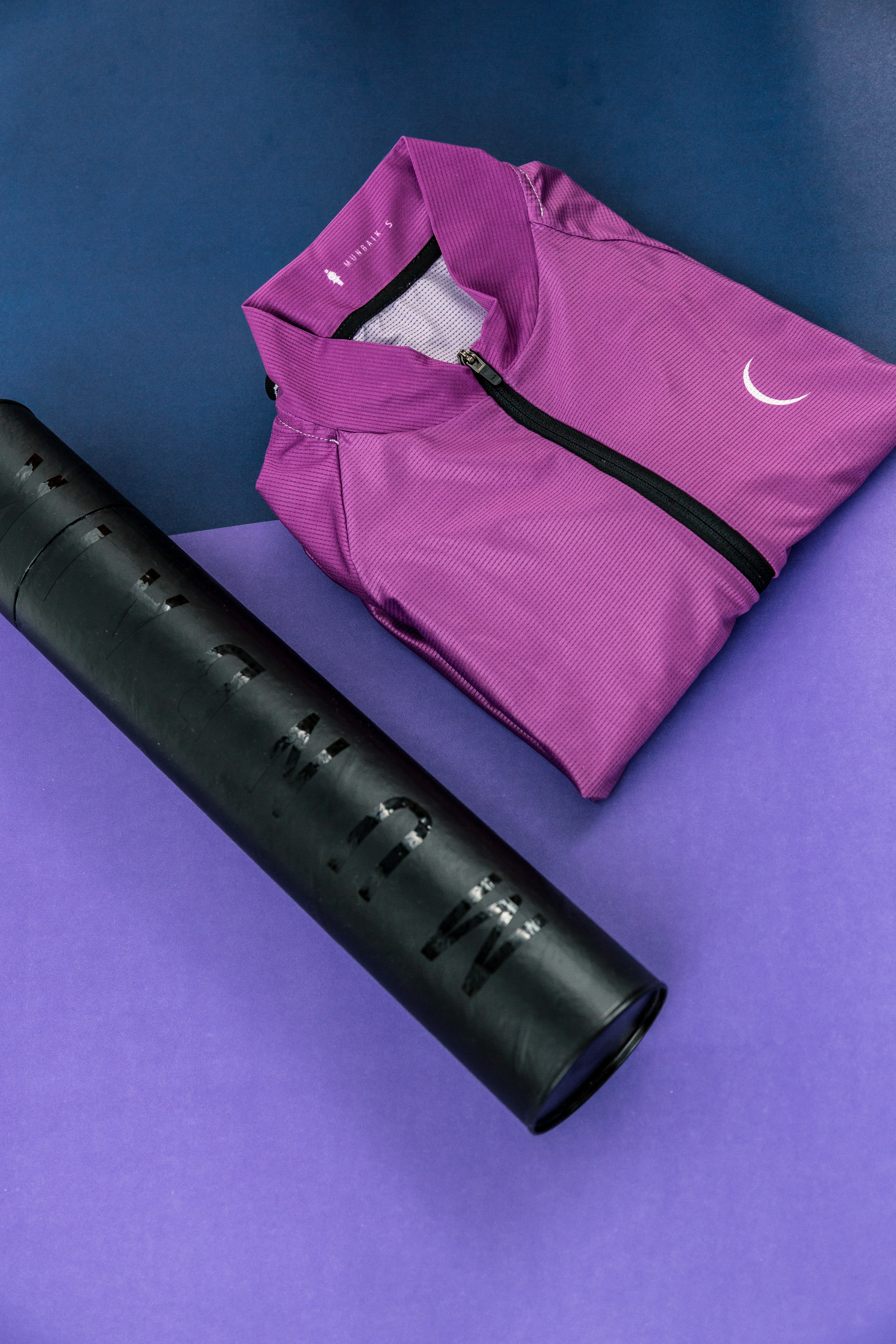 Folded Athletic Shirt and Rolled Yoga Mat