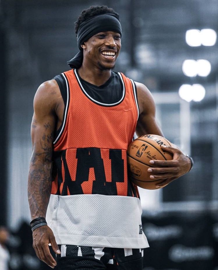 Smiling Basketball Player on Indoor Court