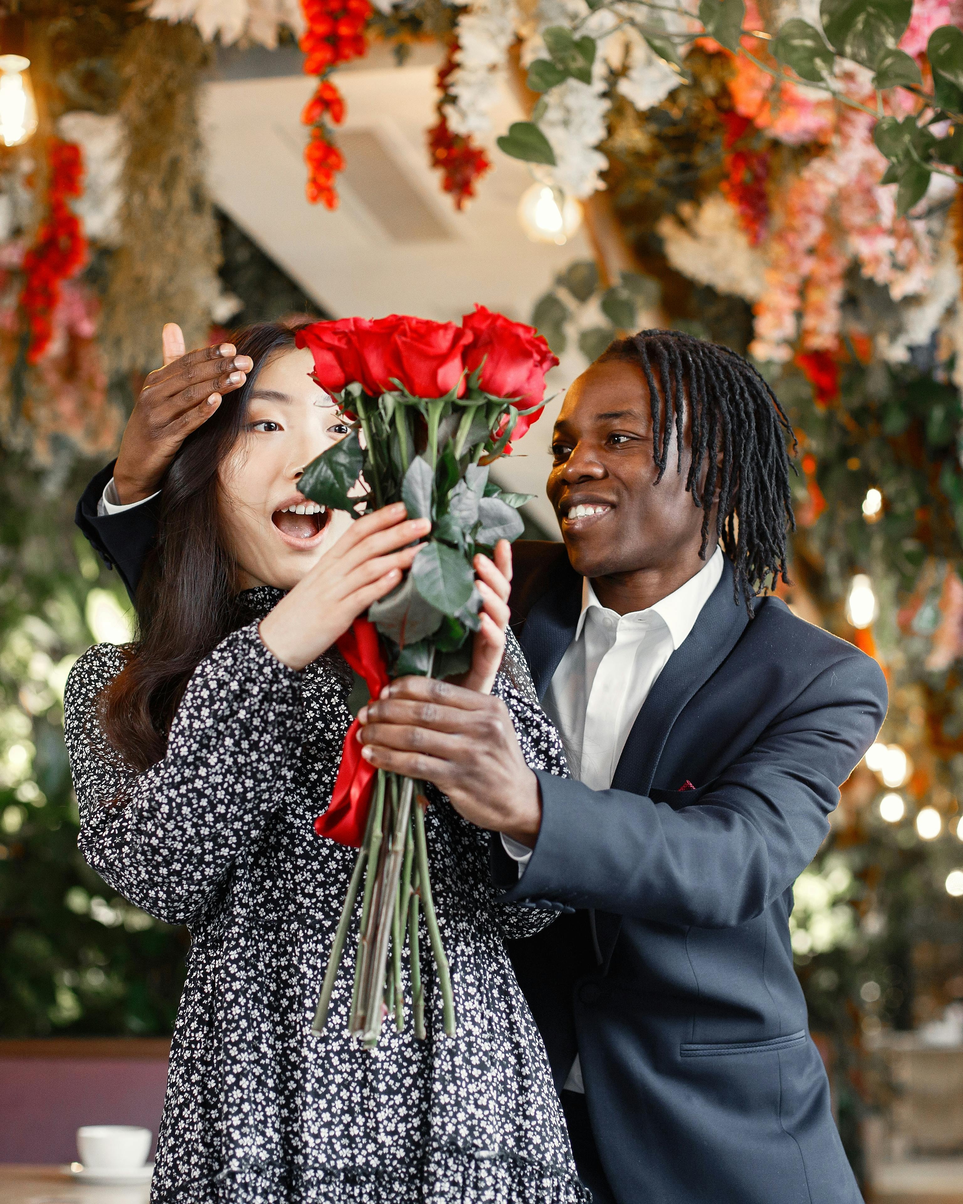 Man Surprises Woman With Red Roses