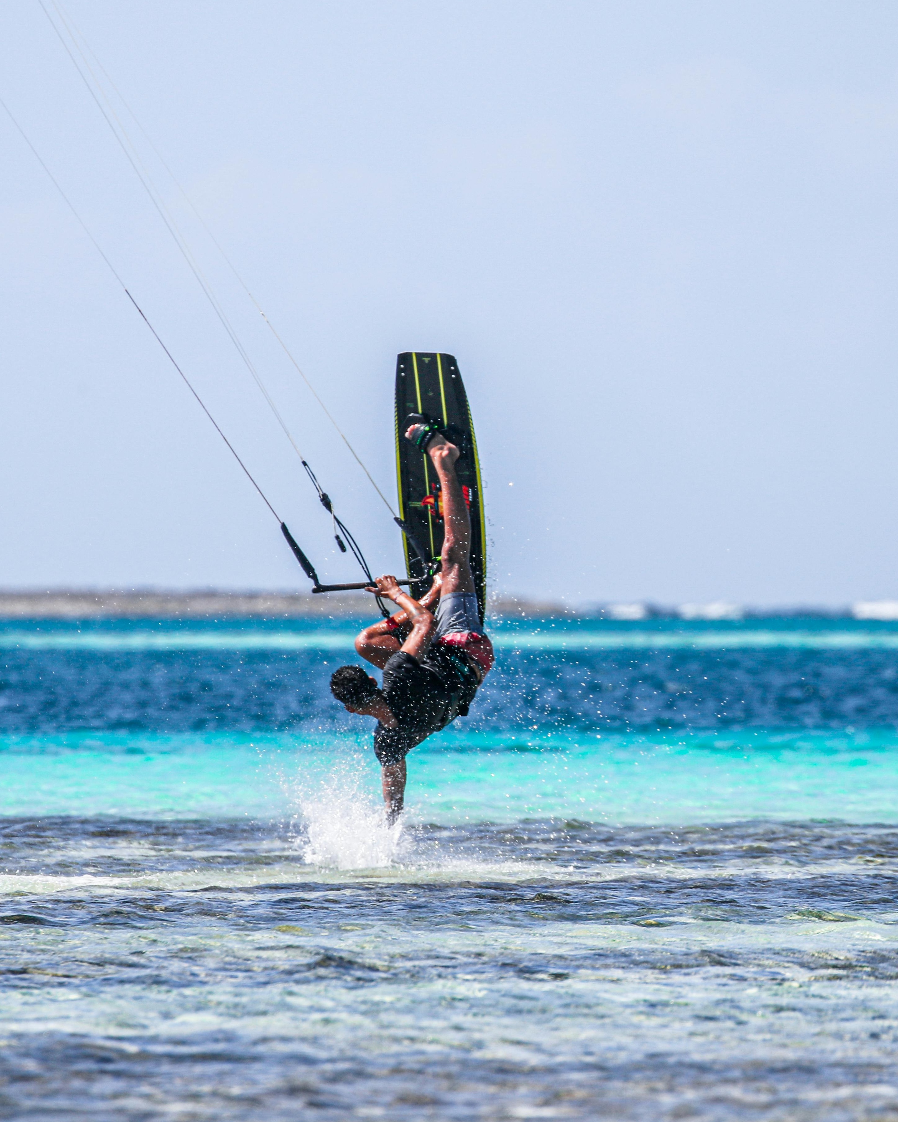 Kiteboarder Doing Trick Over Turquoise Ocean