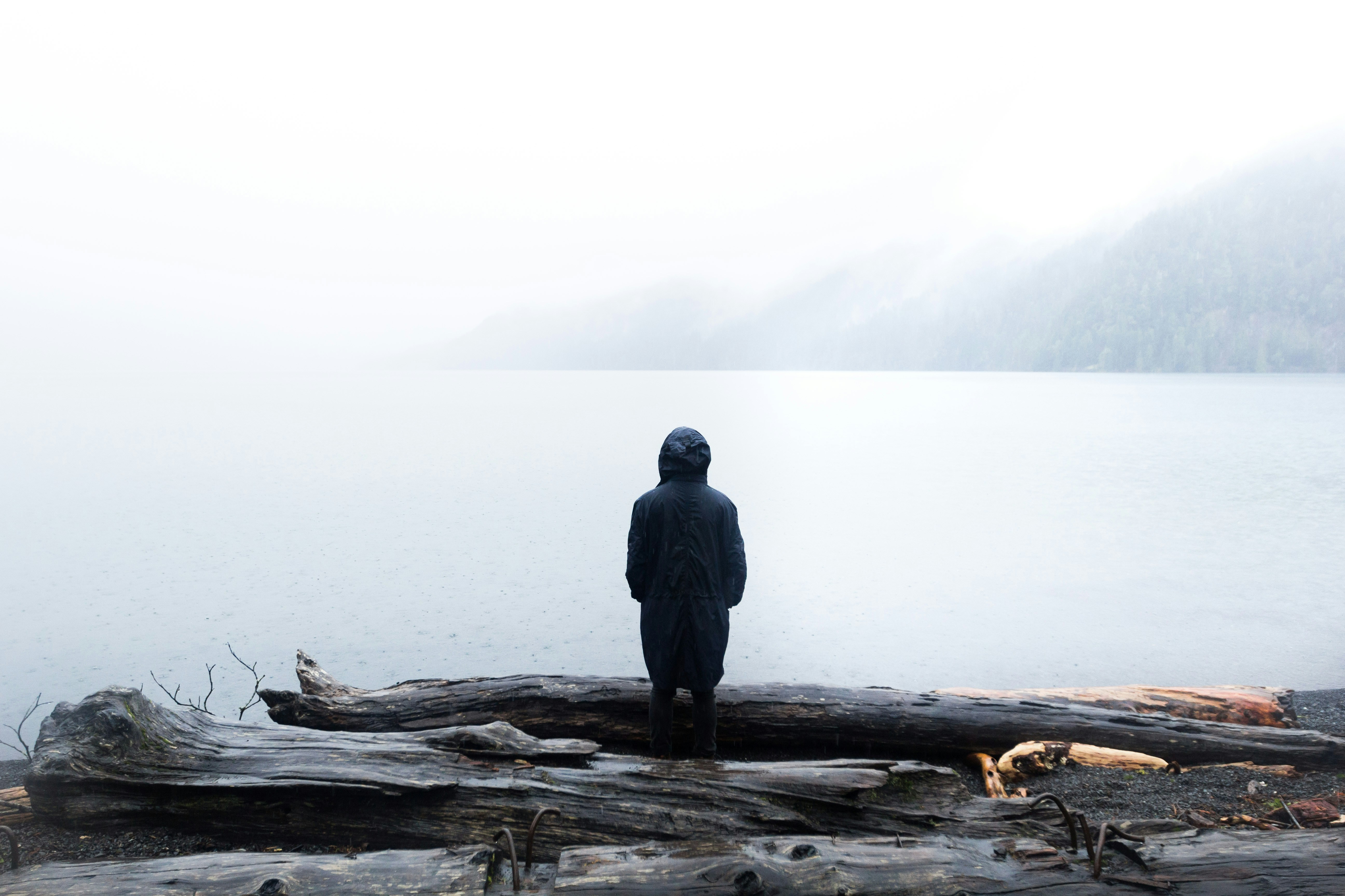 Hooded Figure at Foggy Lakeside