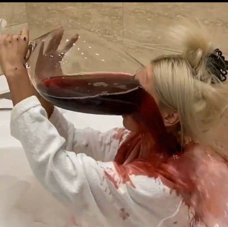 Woman Spills Red Wine From Oversized Glass
