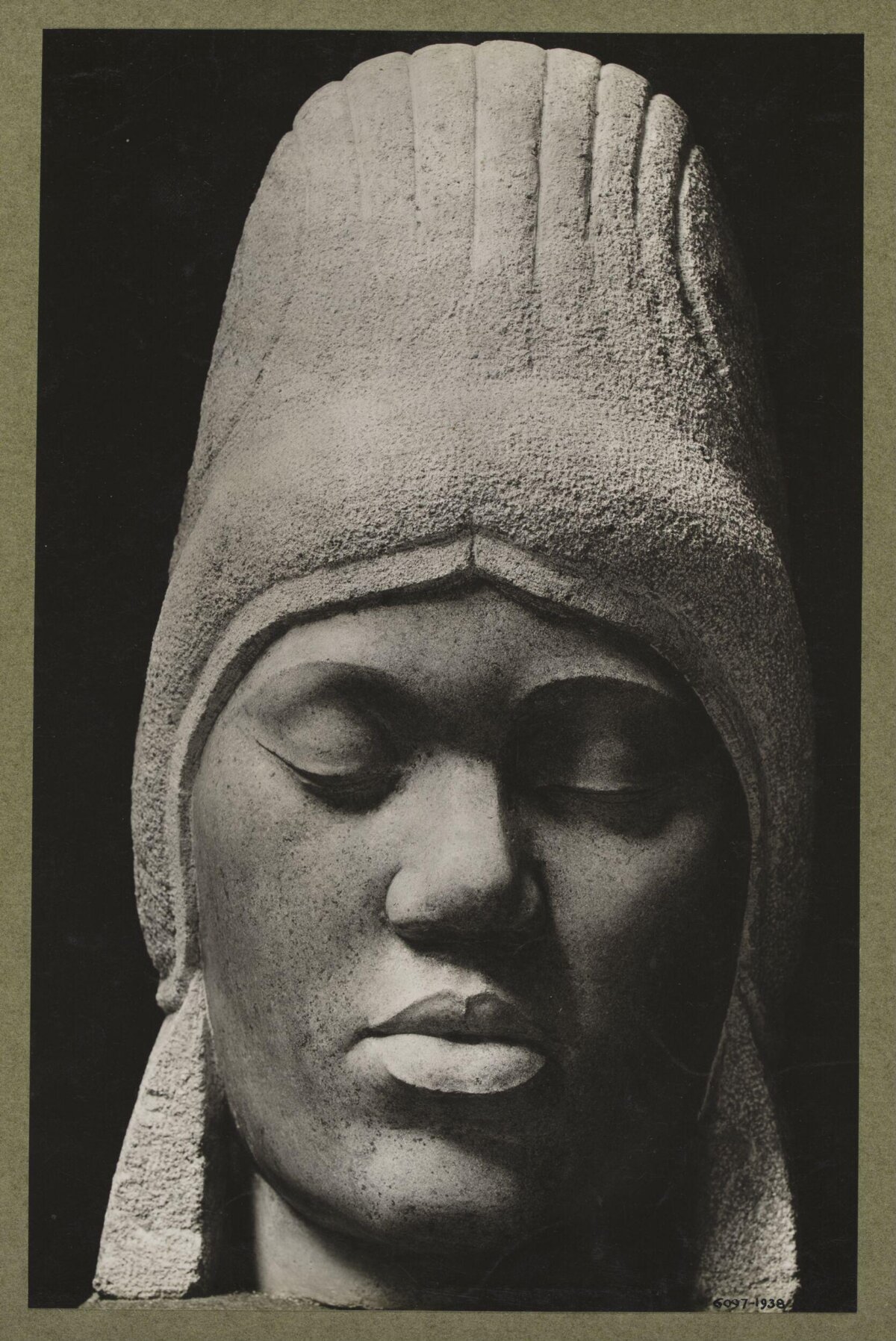 Black and White Photo of Stone Head Sculpture