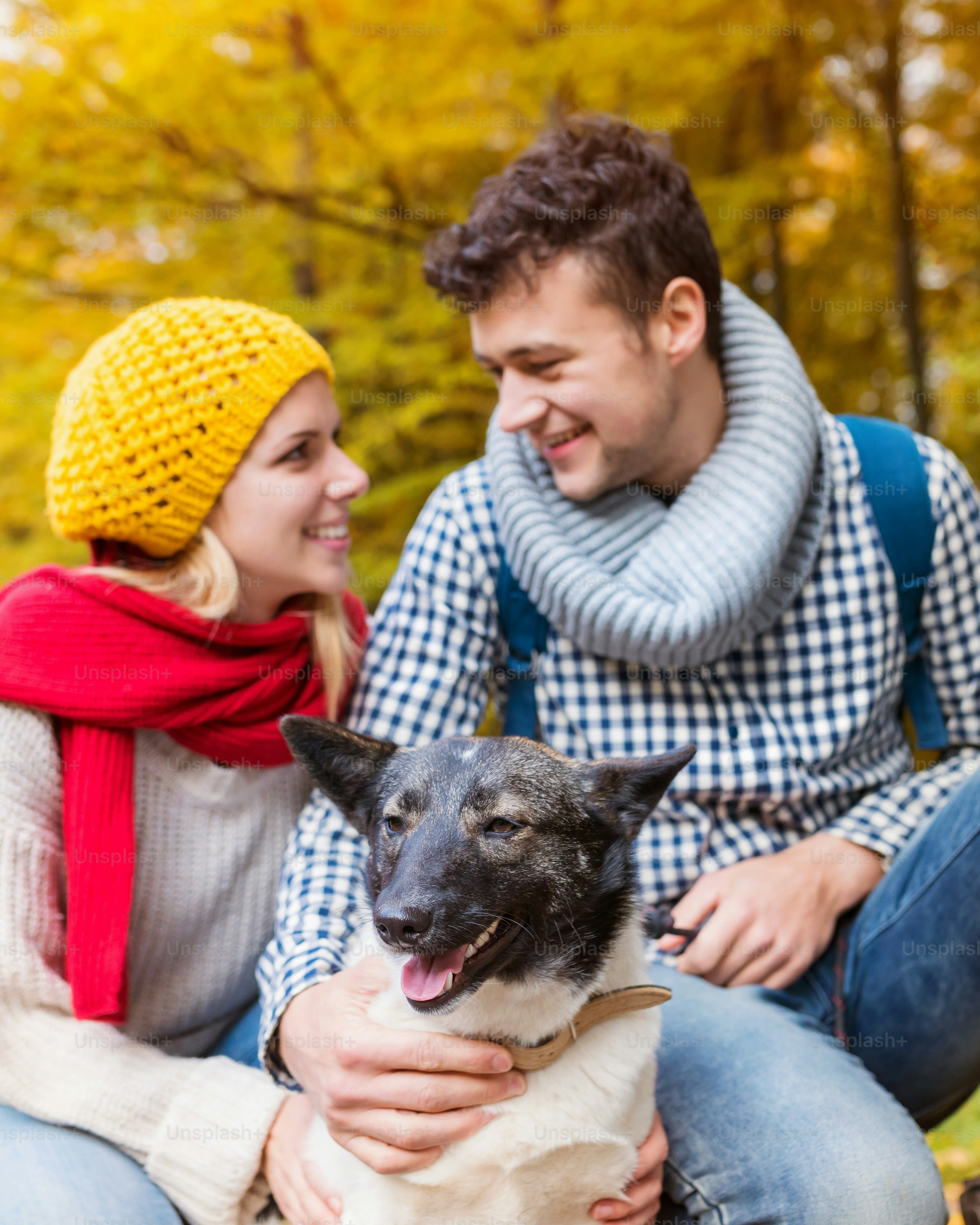 Couple with Dog in Autumn Forest