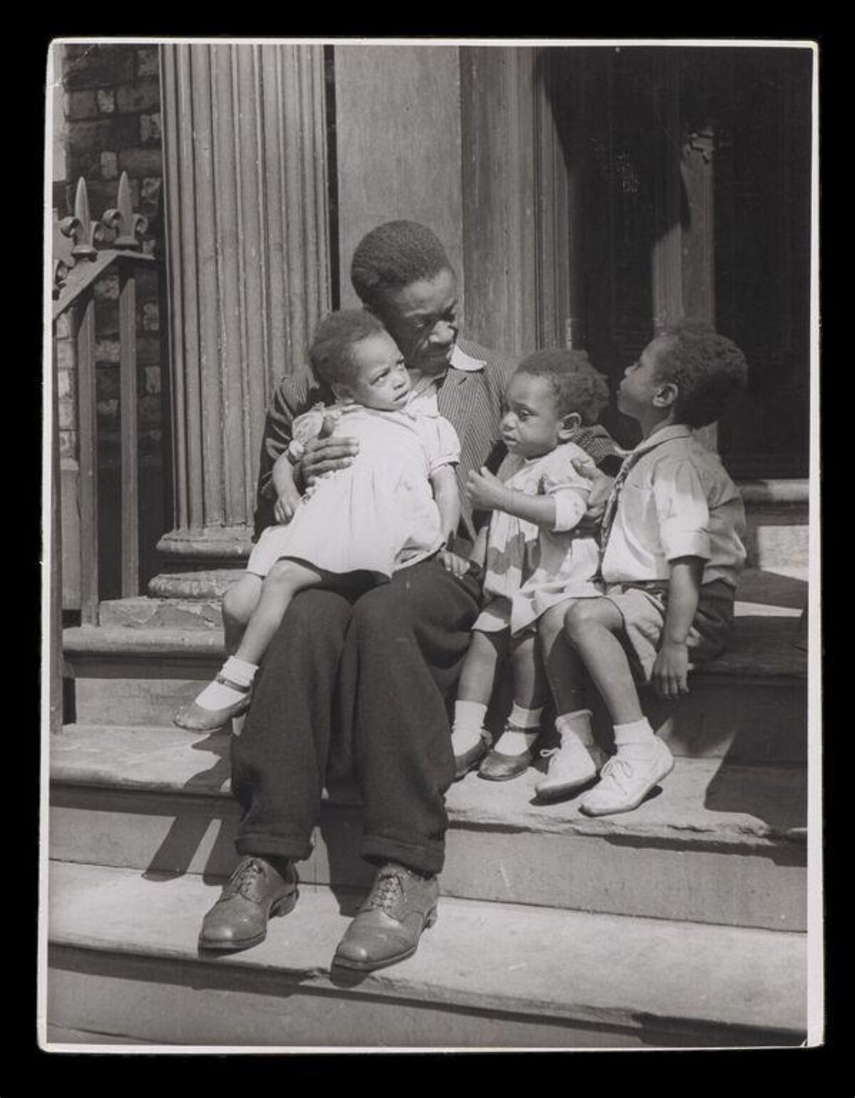 Black Father with Three Children on Stoop