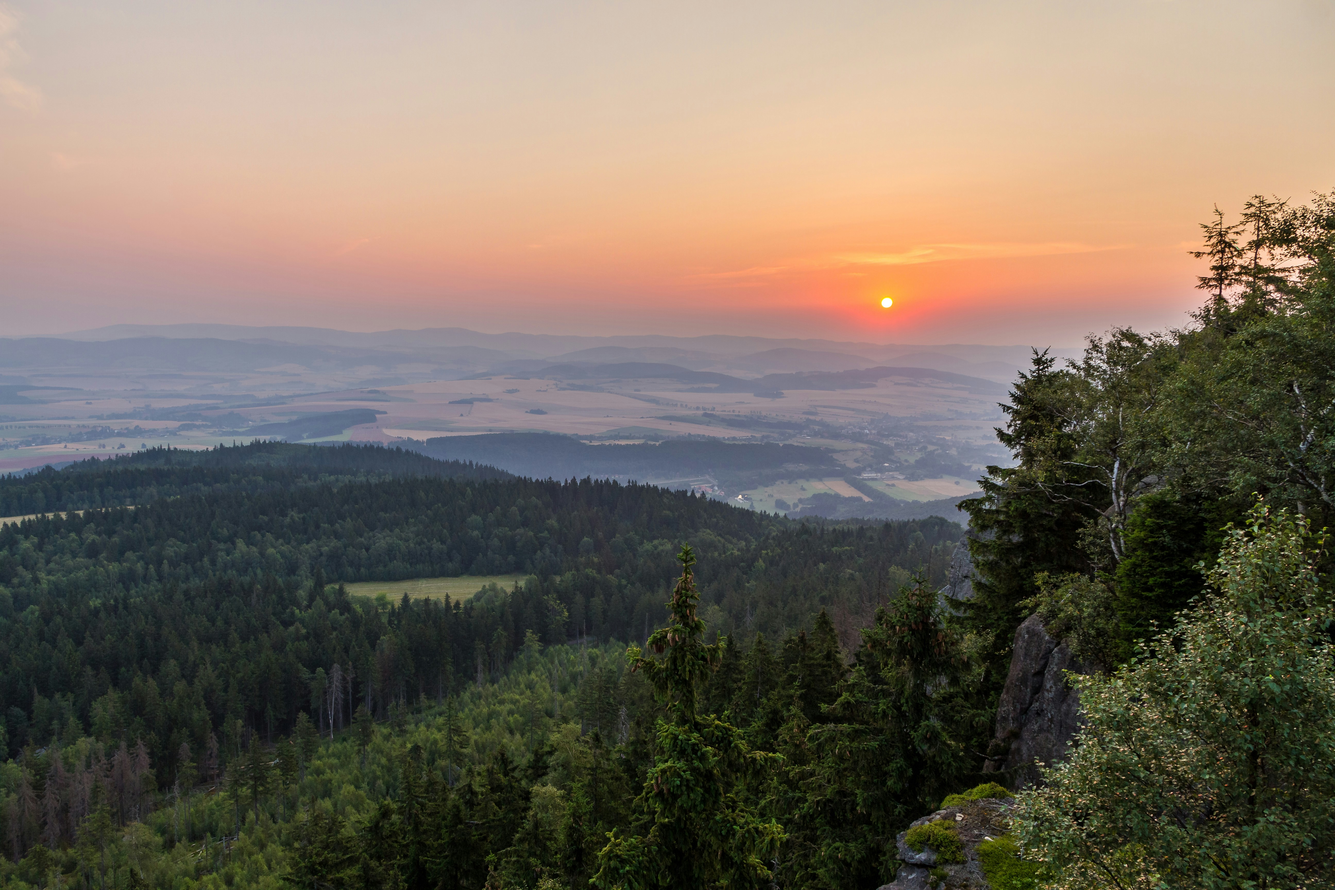 Sunset Over Forested Mountain Valley