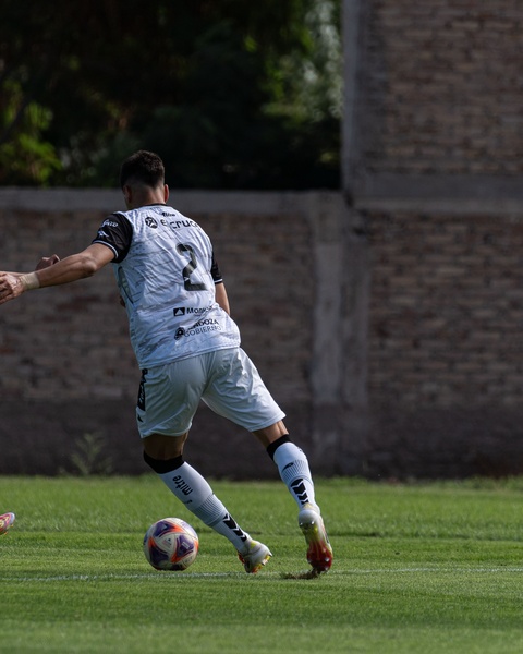 Soccer Player Dribbling on Grass Field