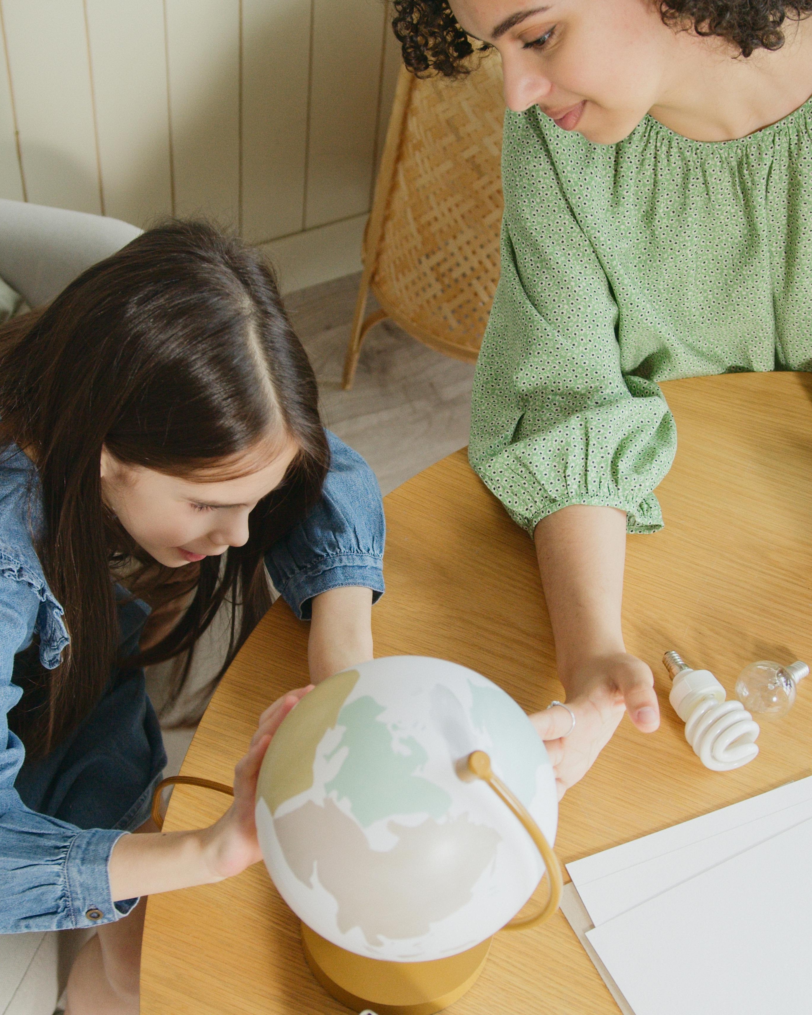 Woman and Girl Assembling Globe Lamp