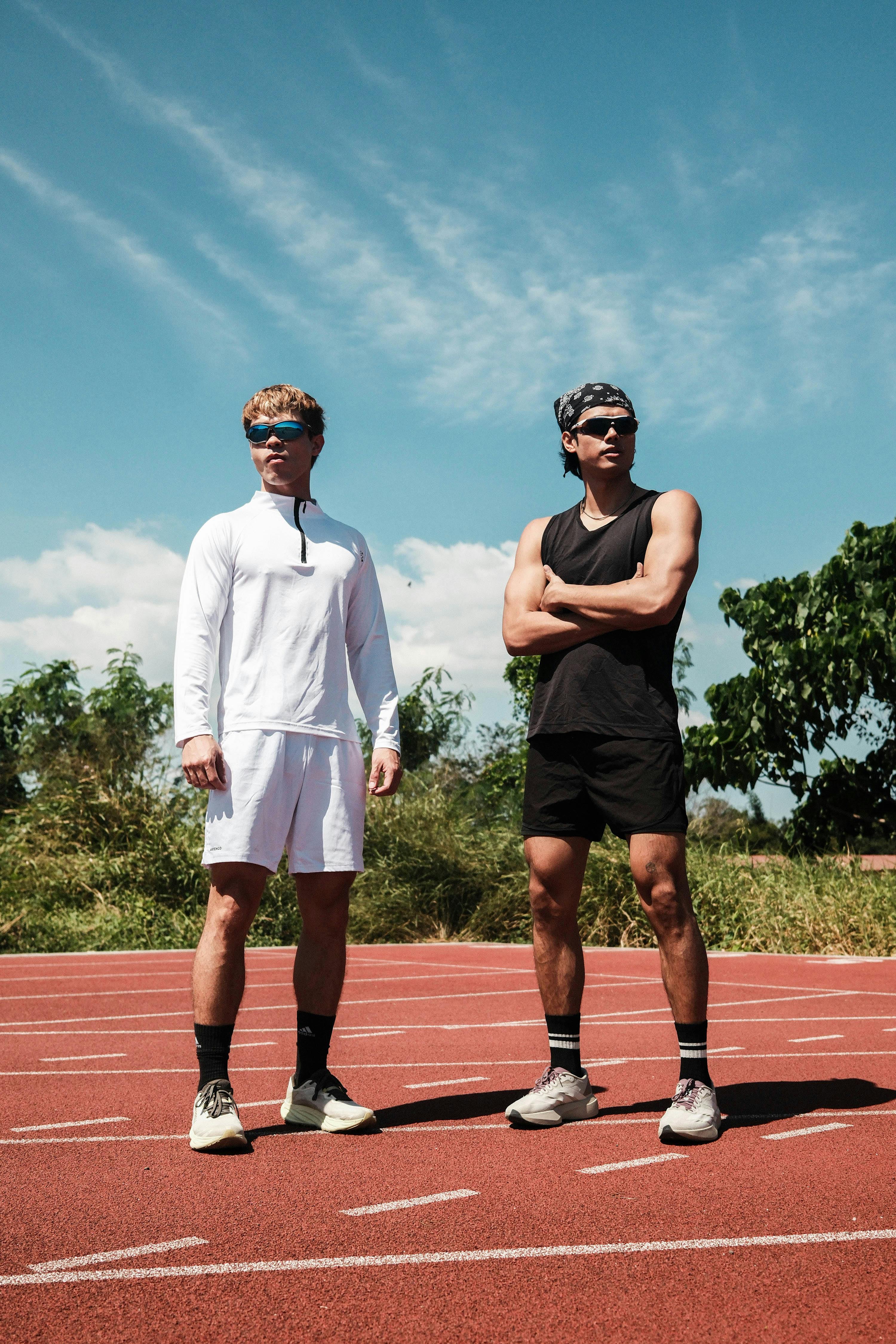 Two Athletes Standing on Running Track