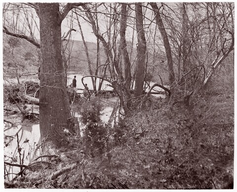 Two Men at Wooded River Bank