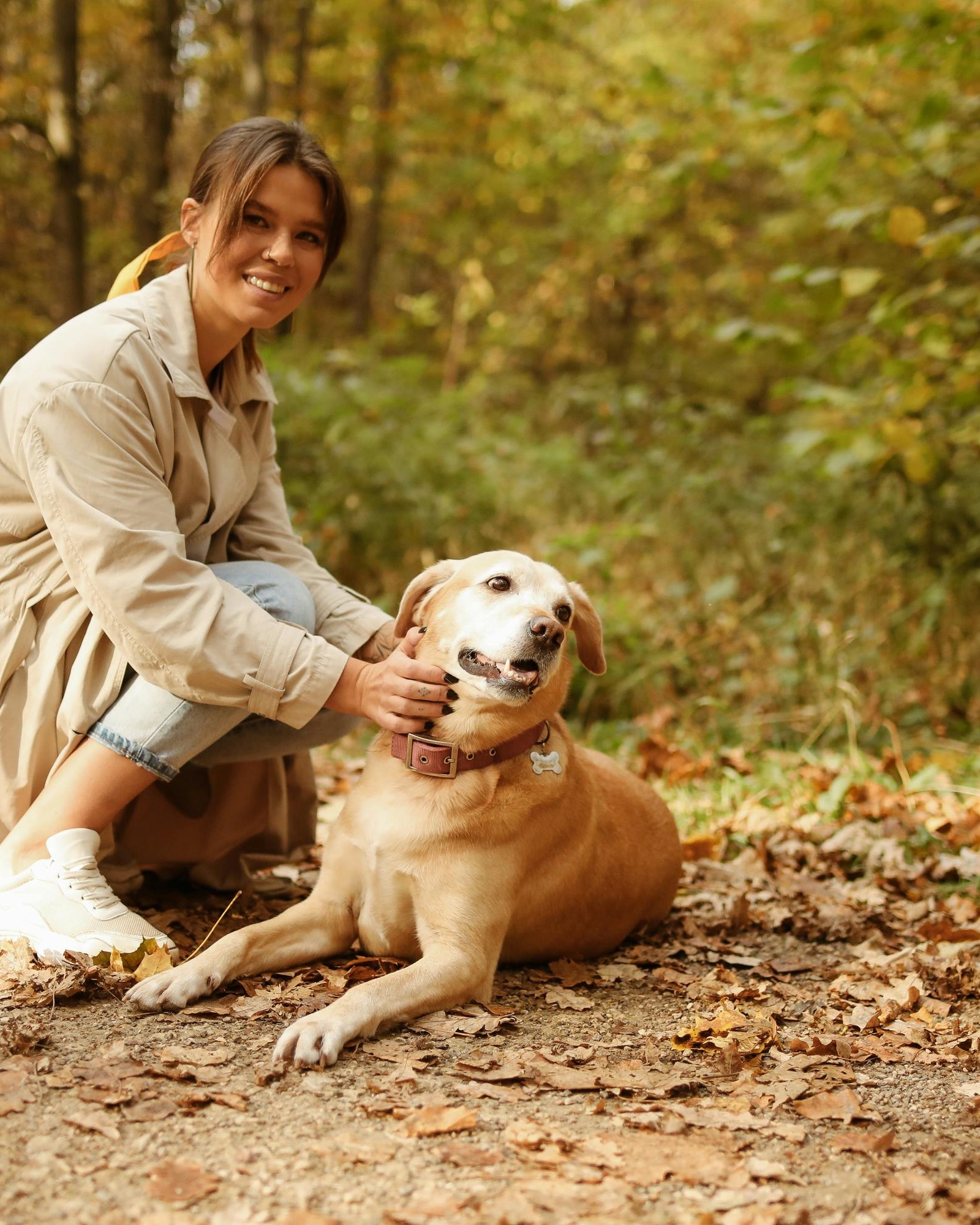 Woman and Dog in Autumn Forest