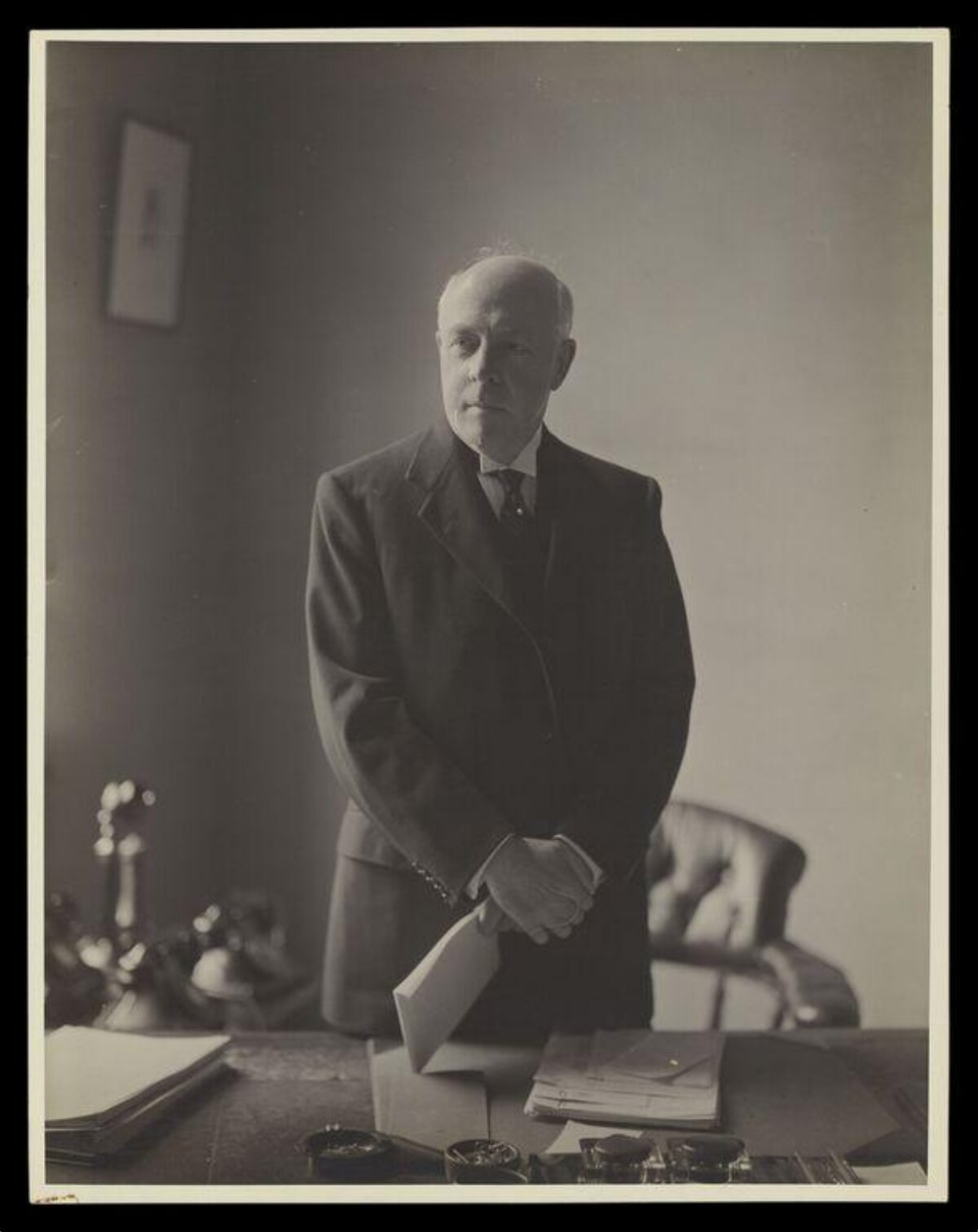 Elderly Man Standing at Office Desk
