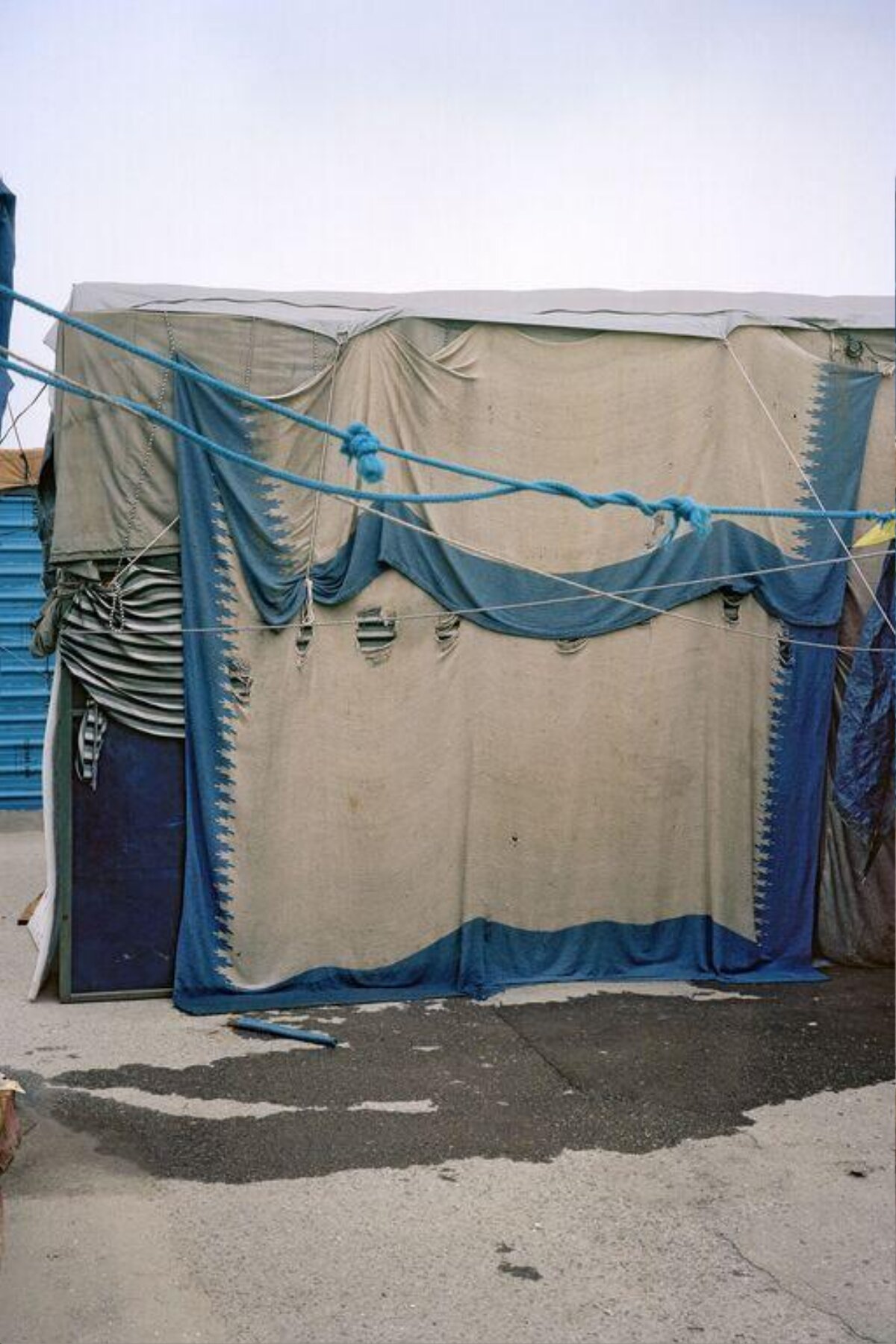 Makeshift Canvas Tent on Pavement