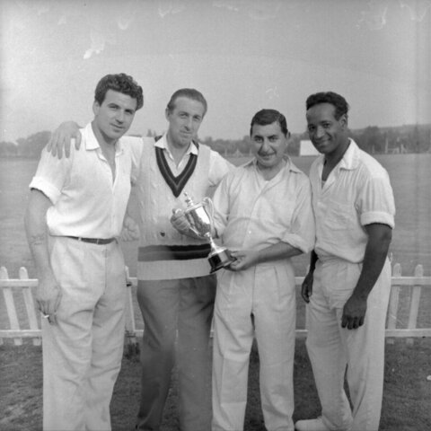 Four Men Posing With Trophy
