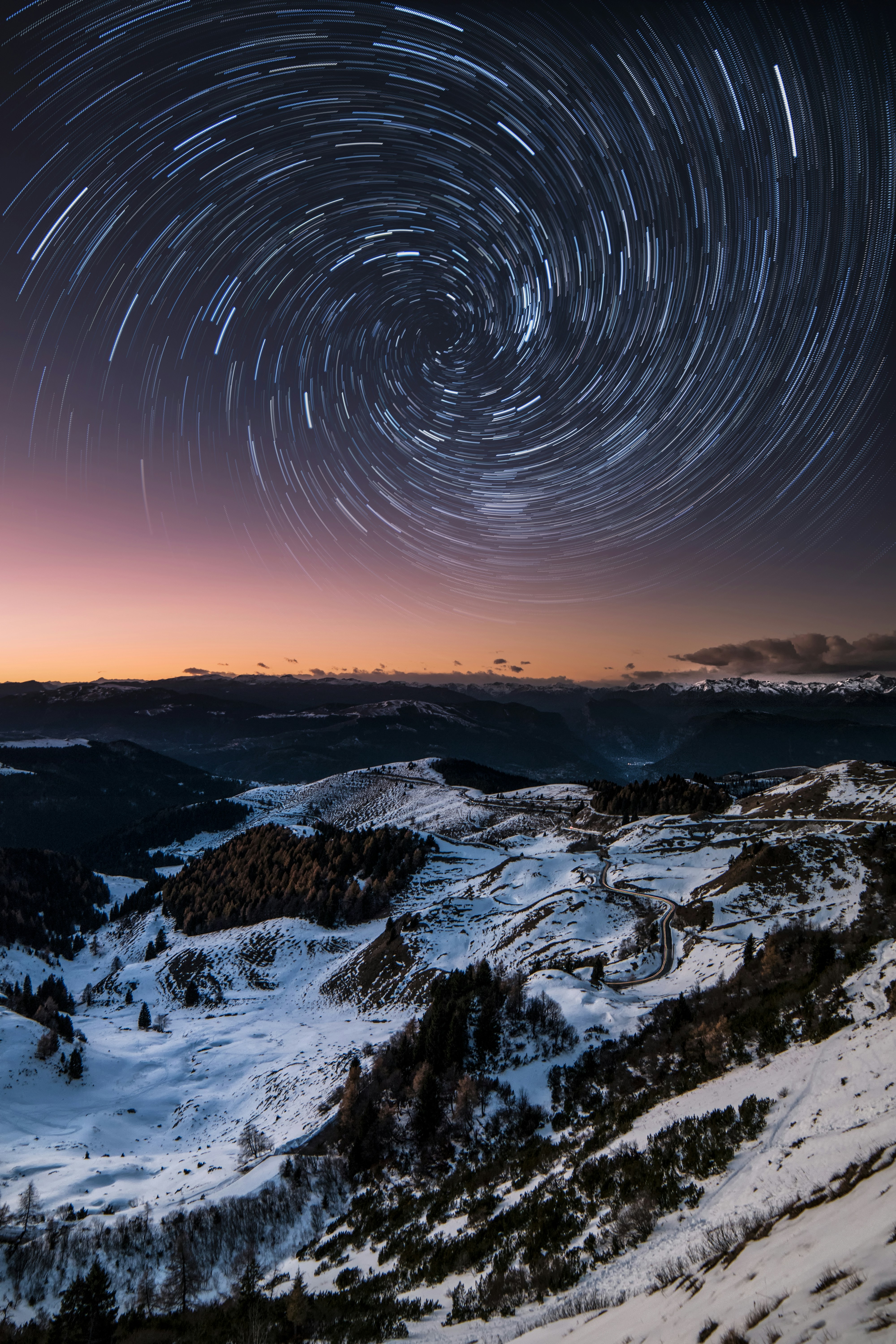 Spiral Star Trails Over Snowy Mountains