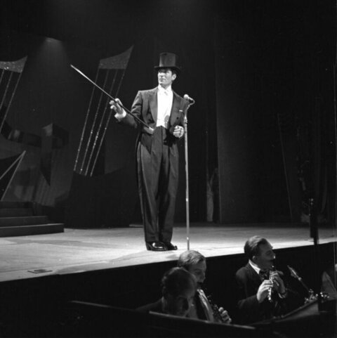 Vintage Performer On Stage With Orchestra
