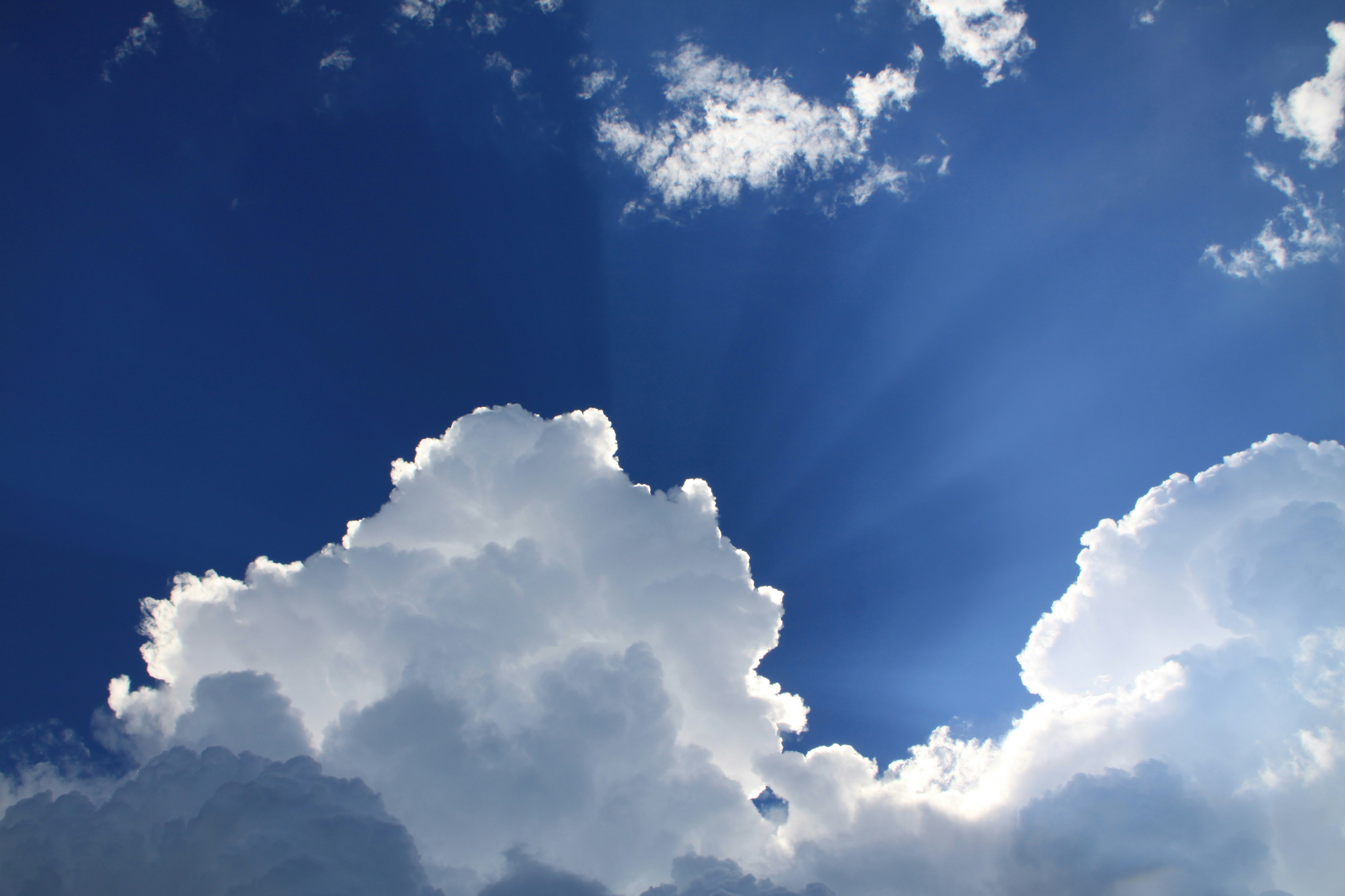 Sunbeams Through Clouds in Blue Sky