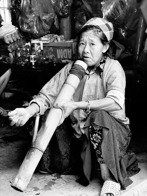 Woman with Traditional Bamboo Pipe