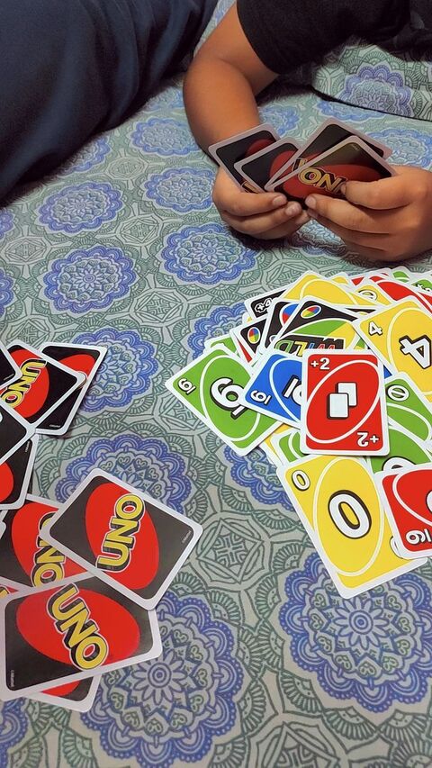 People Playing UNO Card Game