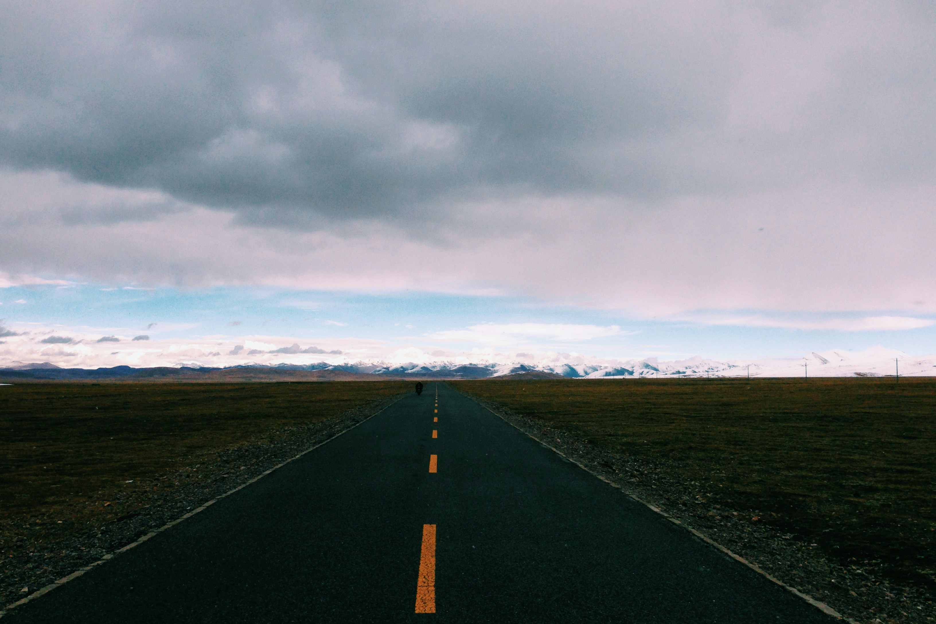 Plateau Road Leading to Snow Mountains