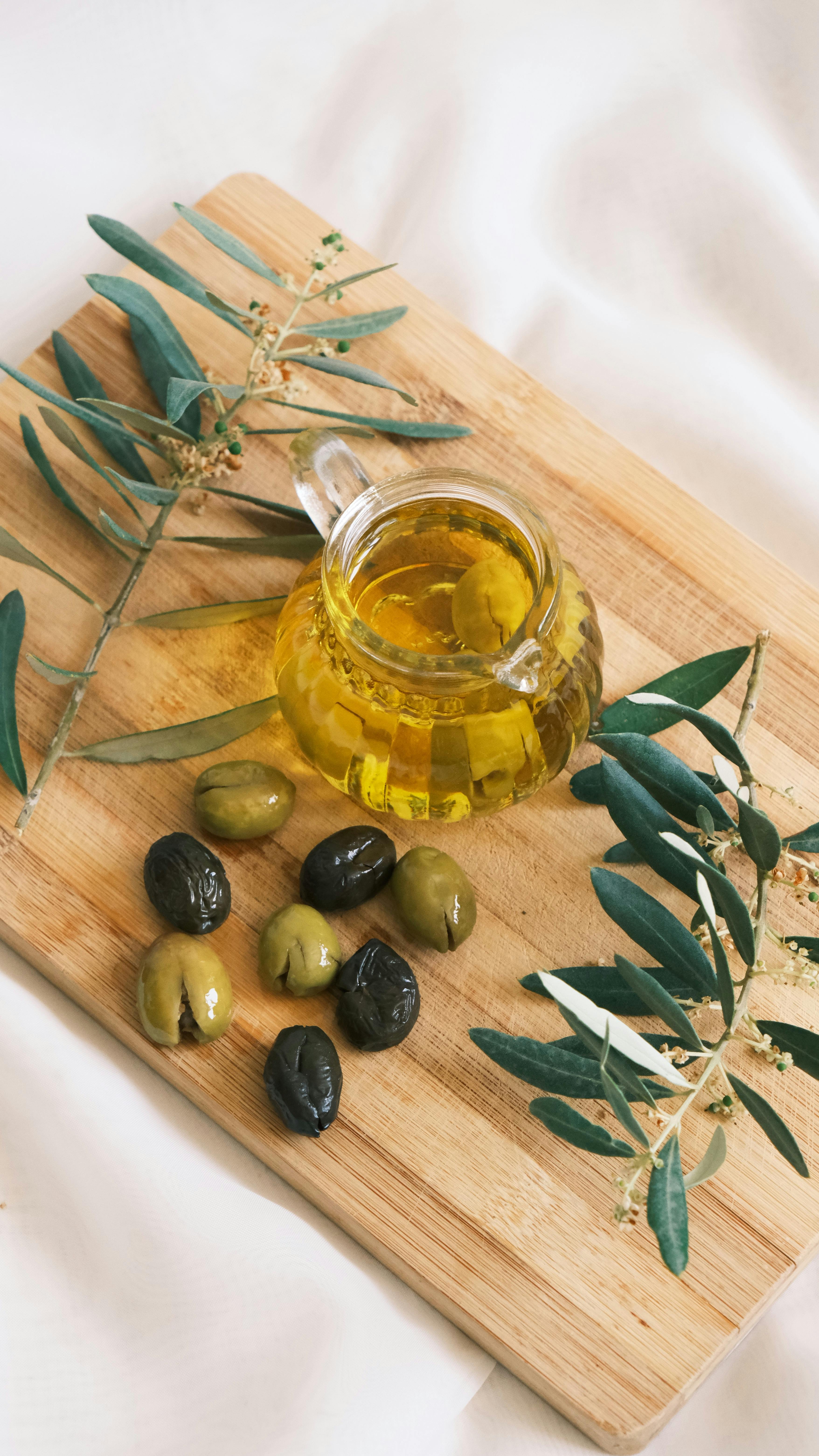 Olives and Olive Oil on Cutting Board