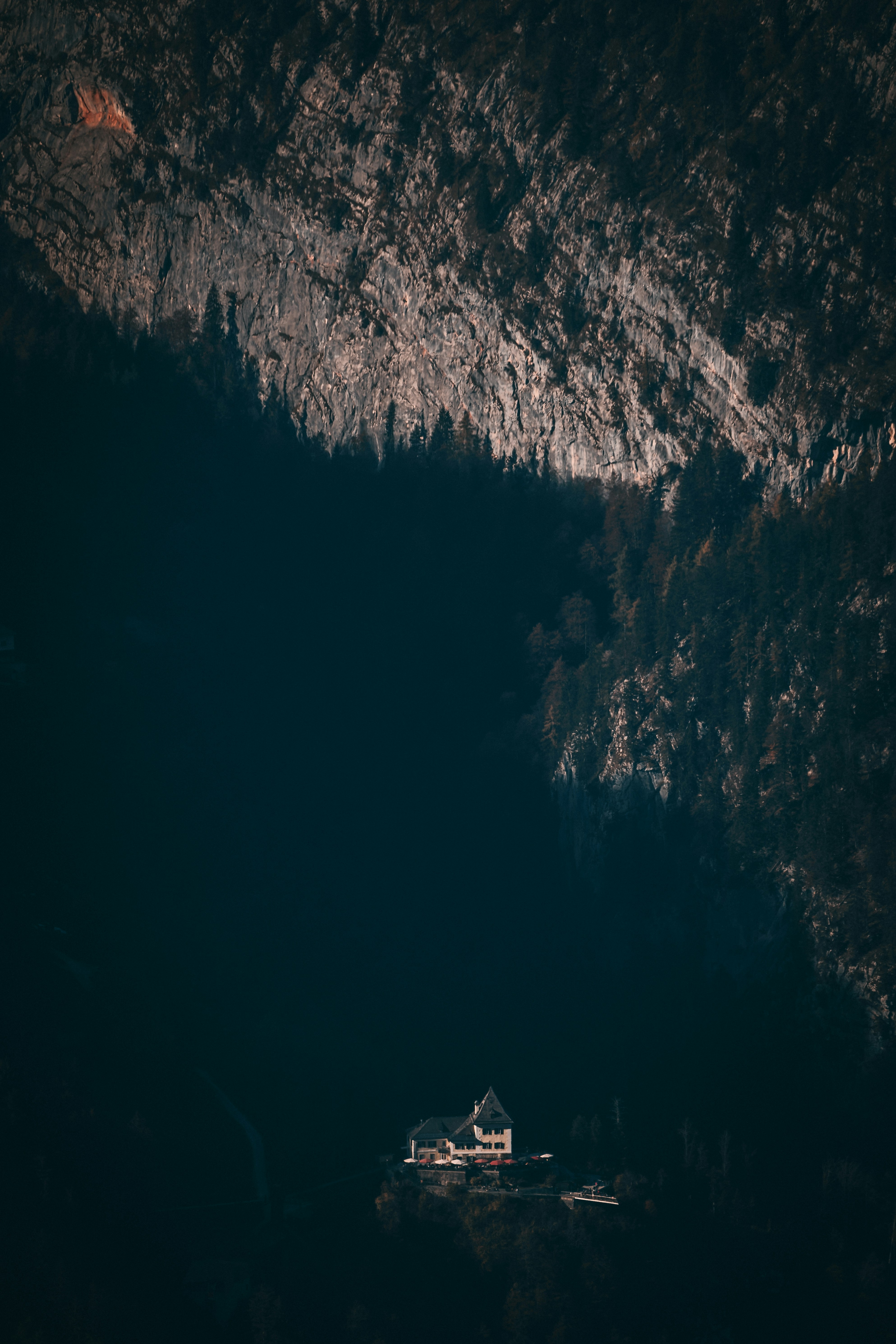 Lone House on Steep Mountain Cliff