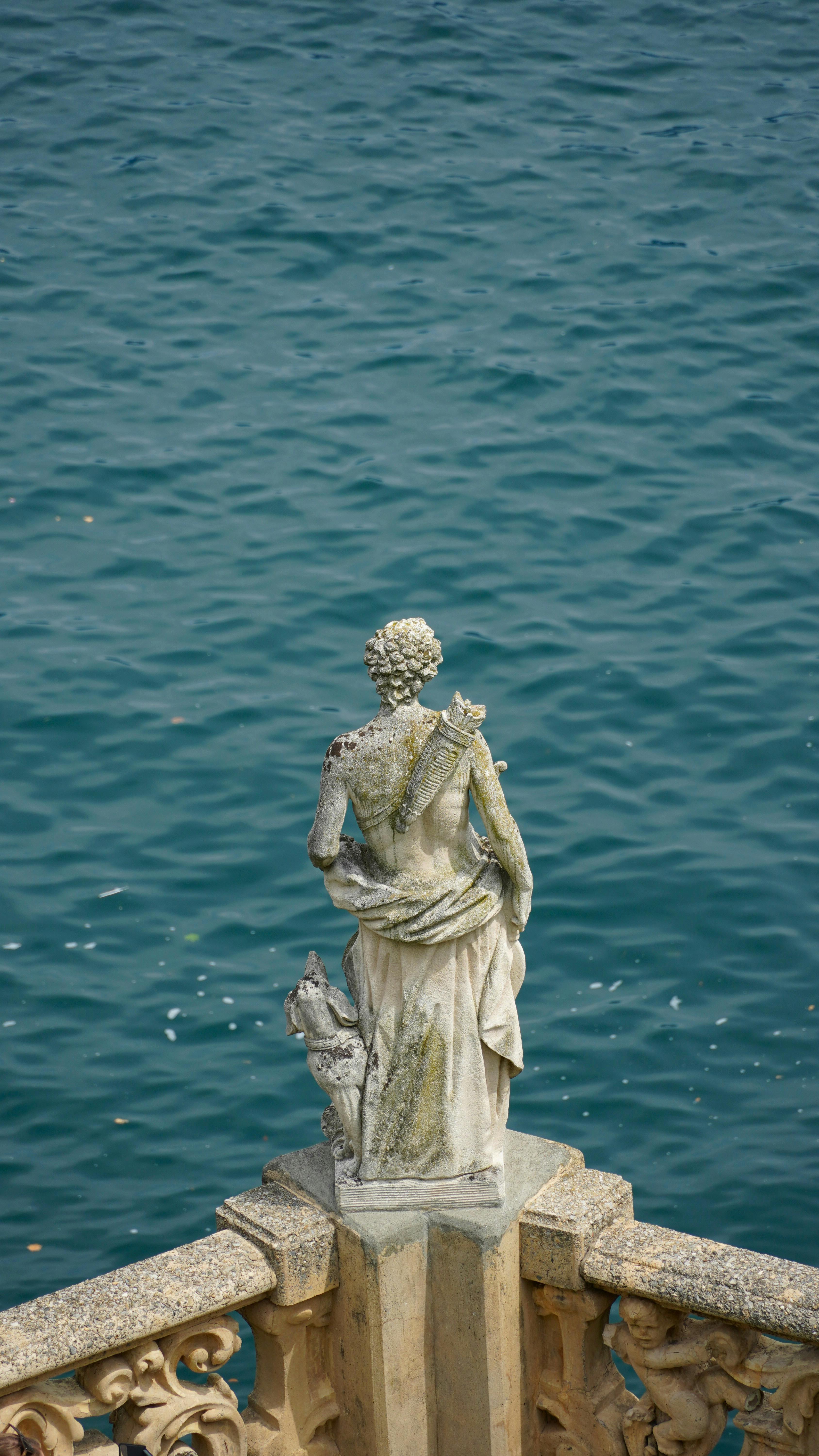 Stone Statue Overlooking Blue Lake