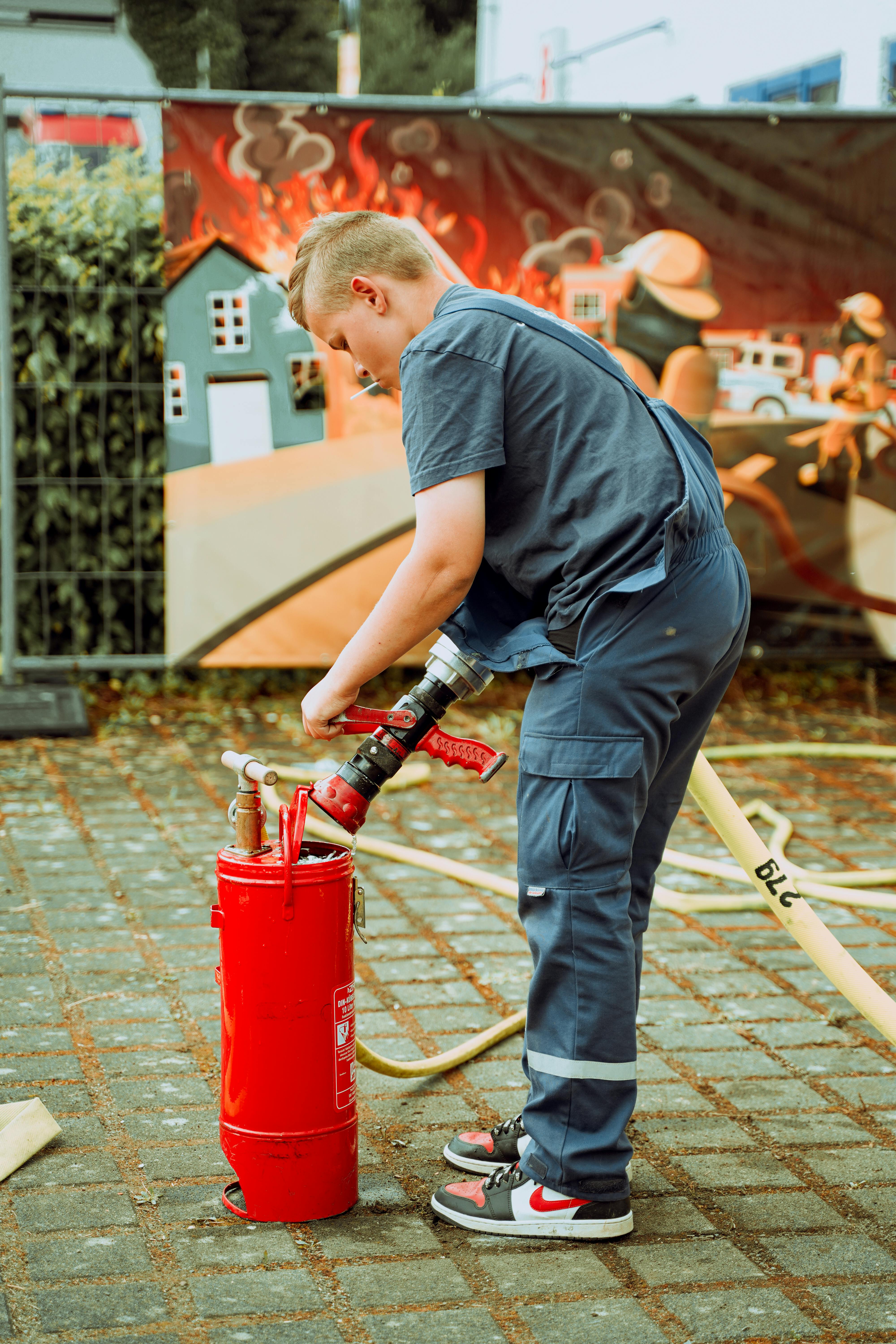 Firefighter Trainee Prepares Fire Hose