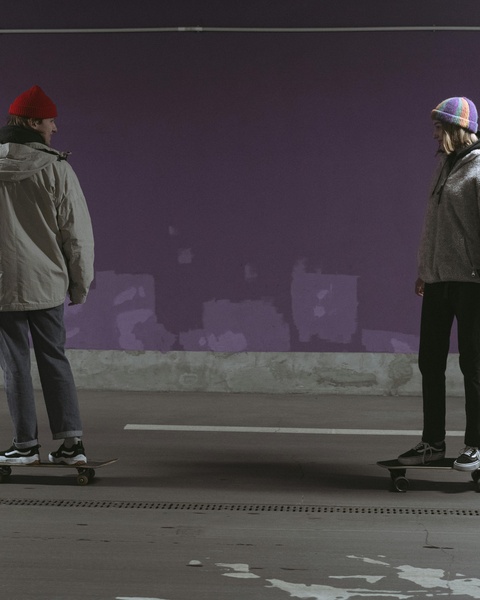 Two Skaters Facing Each Other