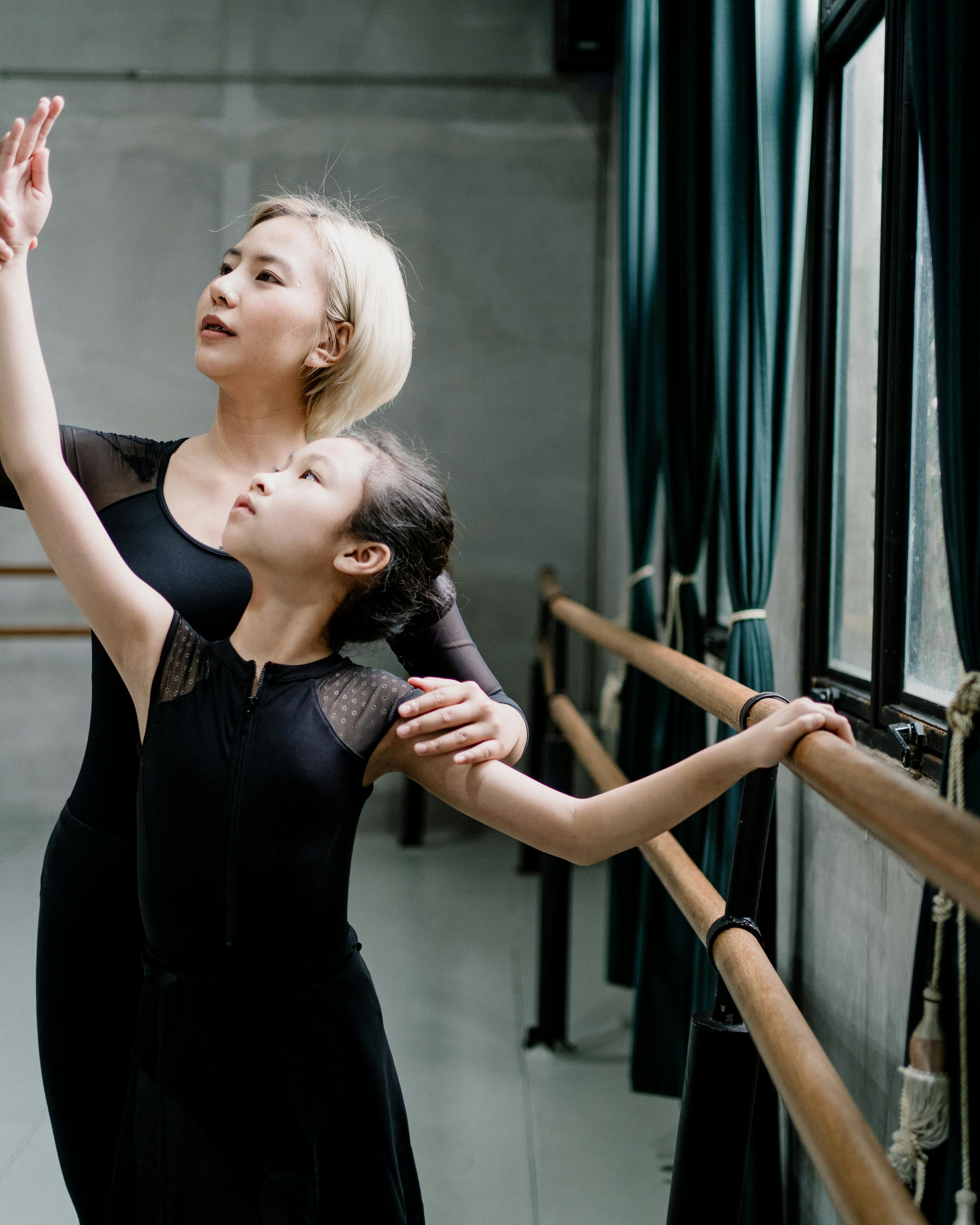 Ballet Instructor Coaching Young Student in Studio