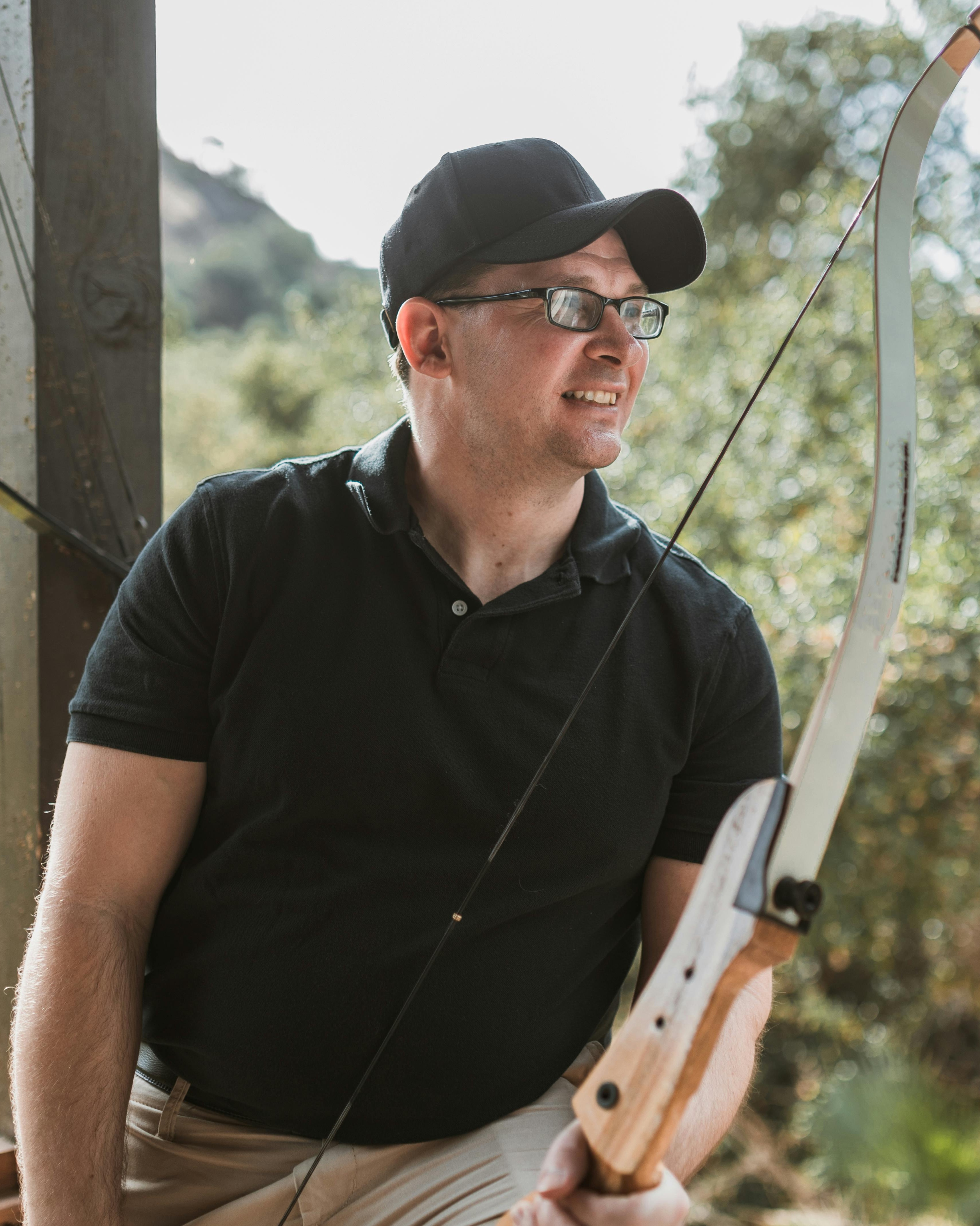 Man Holding Recurve Bow At Outdoor Archery Range