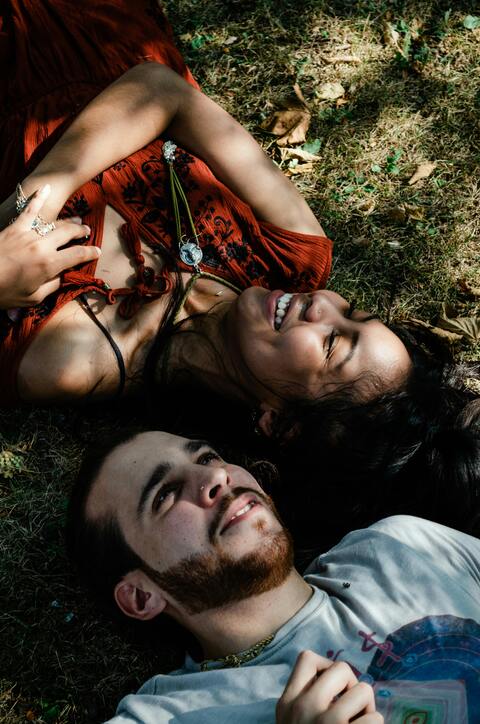 Happy Couple Lying On Grass