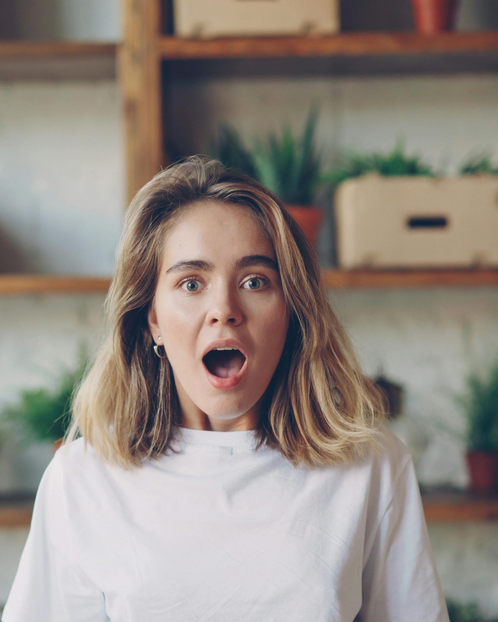 Surprised Young Woman Staring at Camera