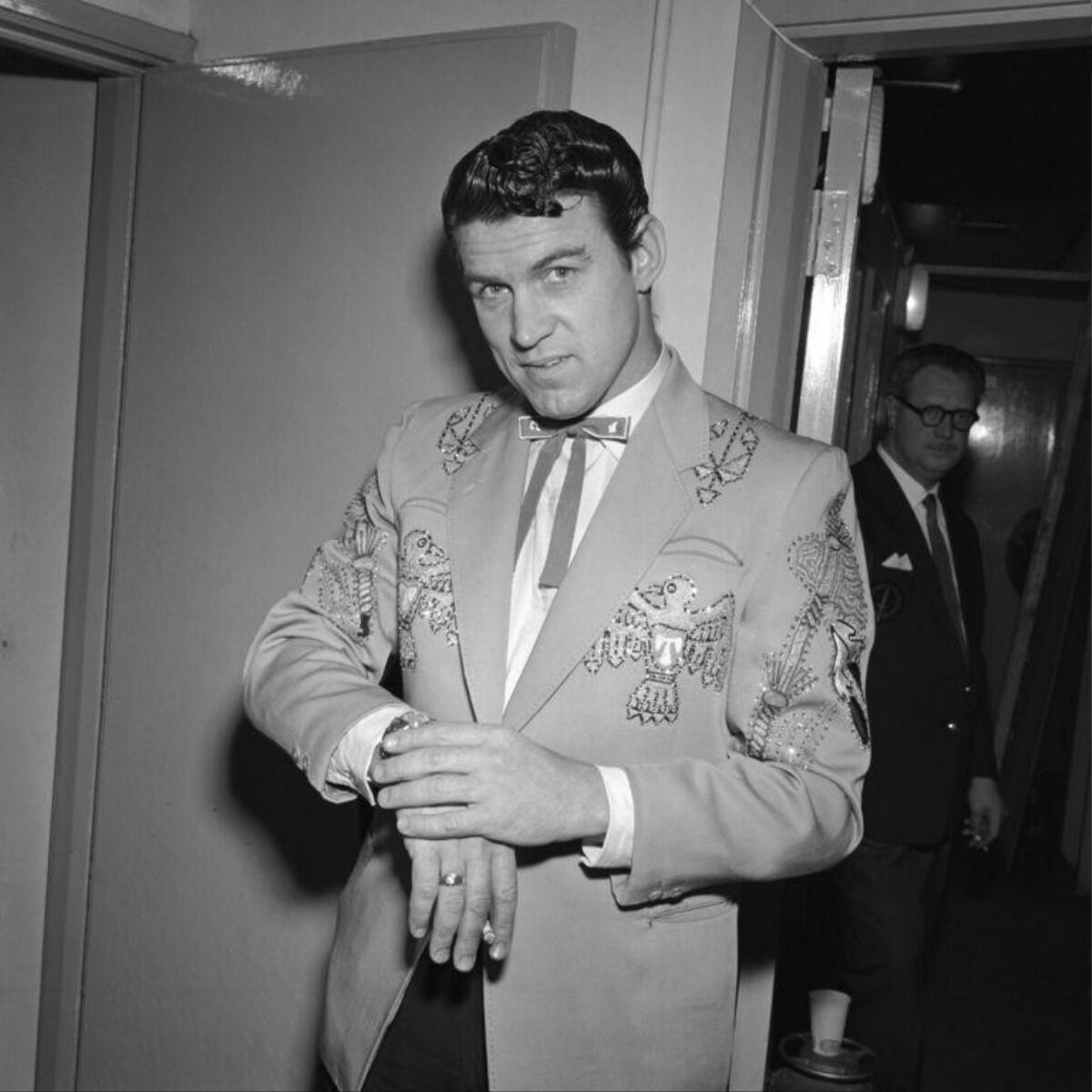Man in embroidered western suit backstage