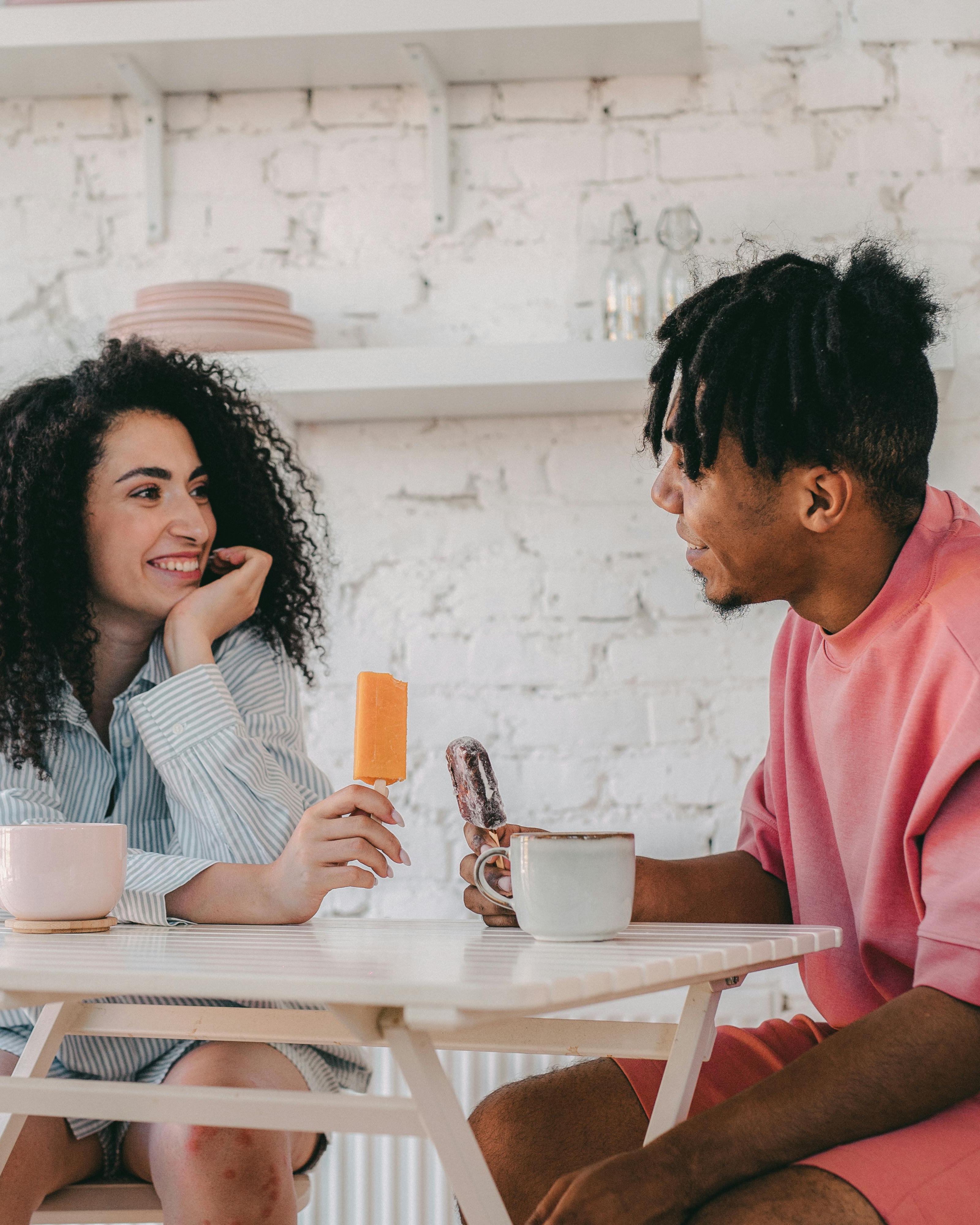 Couple Chatting While Holding Popsicles