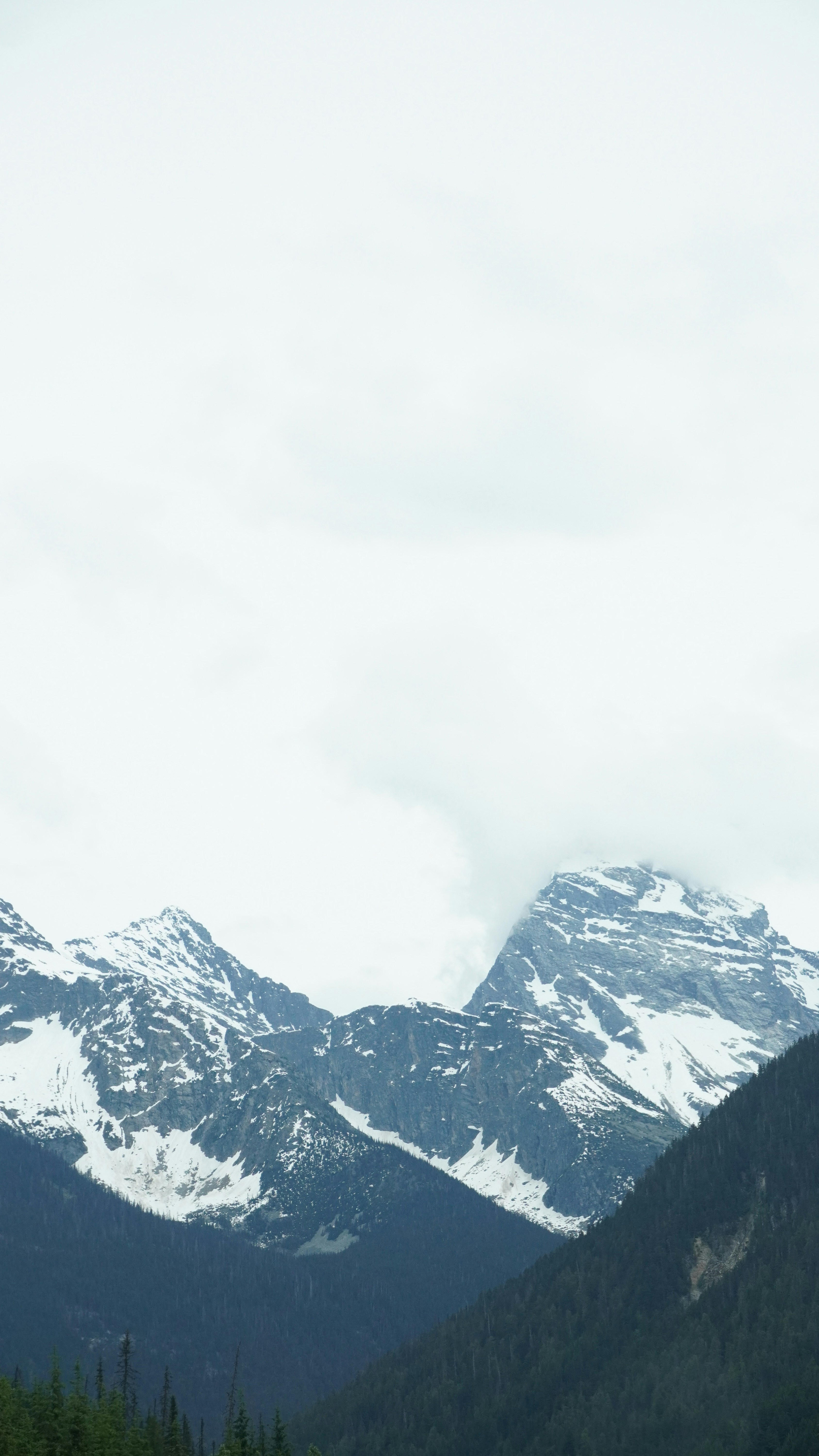 Snow-Capped Mountain Peaks in Fog