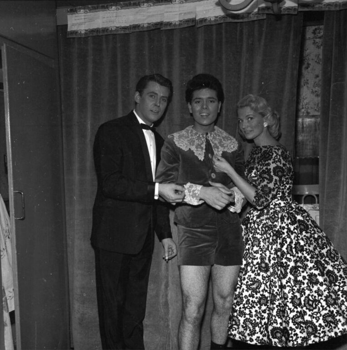 Three Celebrities Posing Backstage