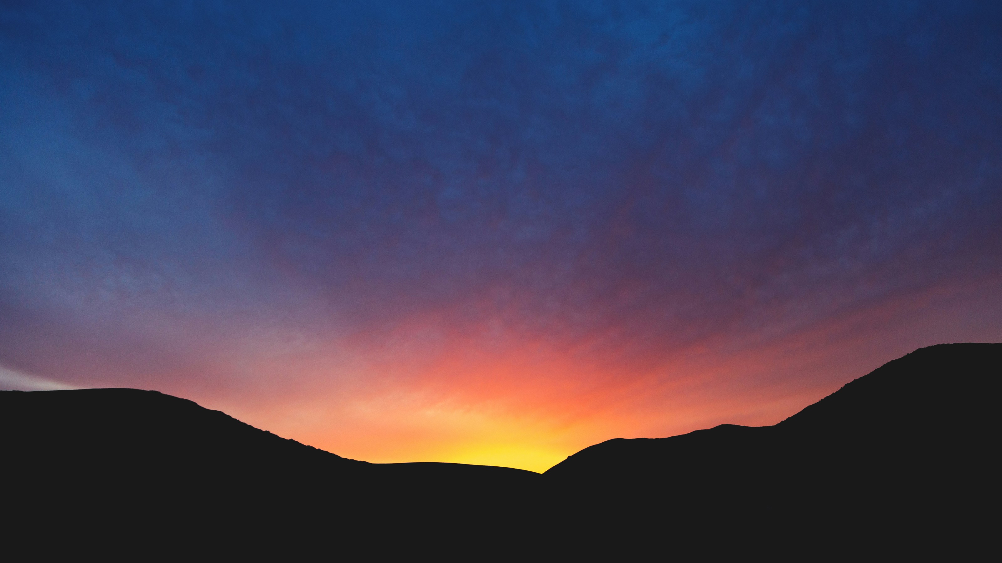 Sunset Over Silhouetted Hills